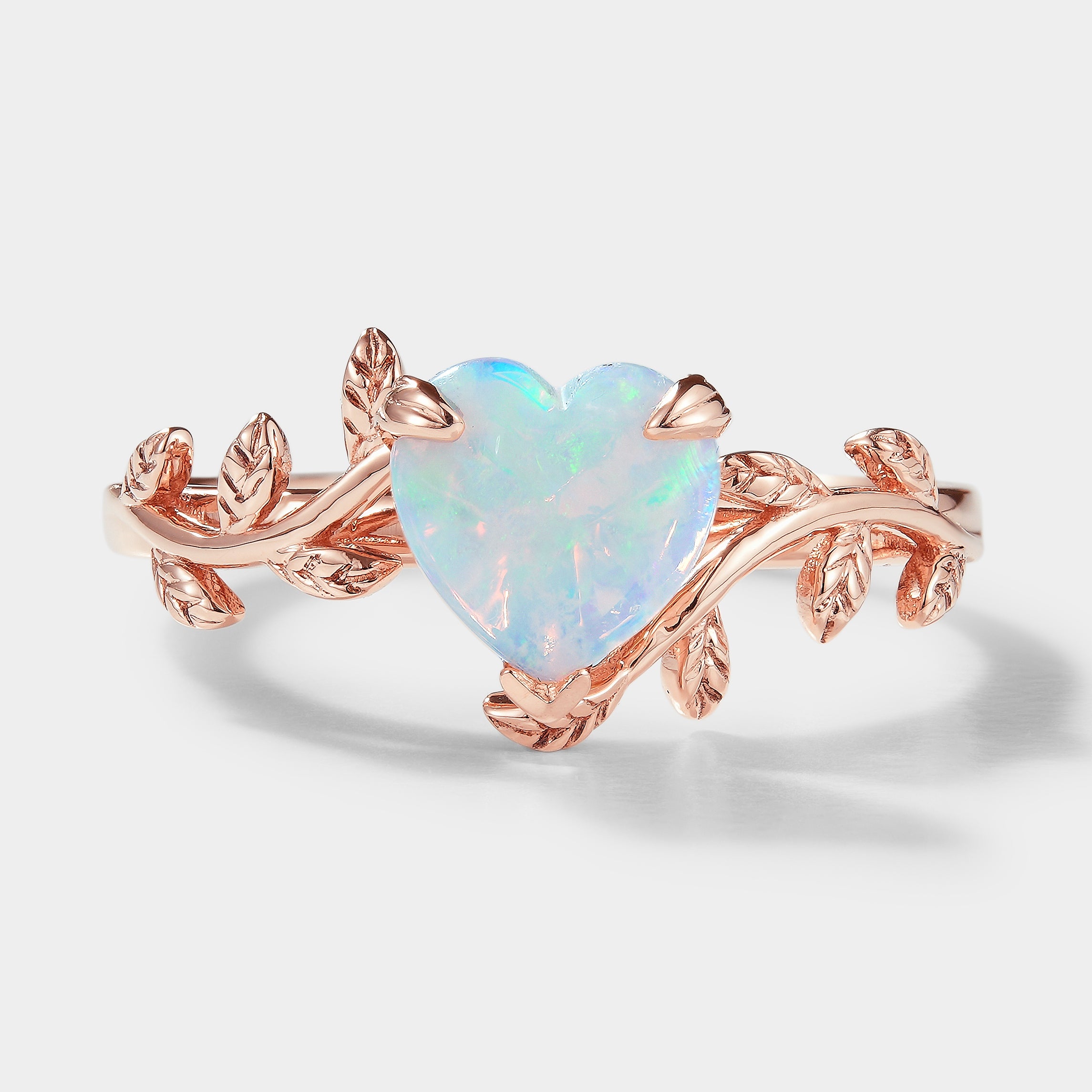 Heart-cut opal engagement ring with leaf design by Lahela Jewelry
