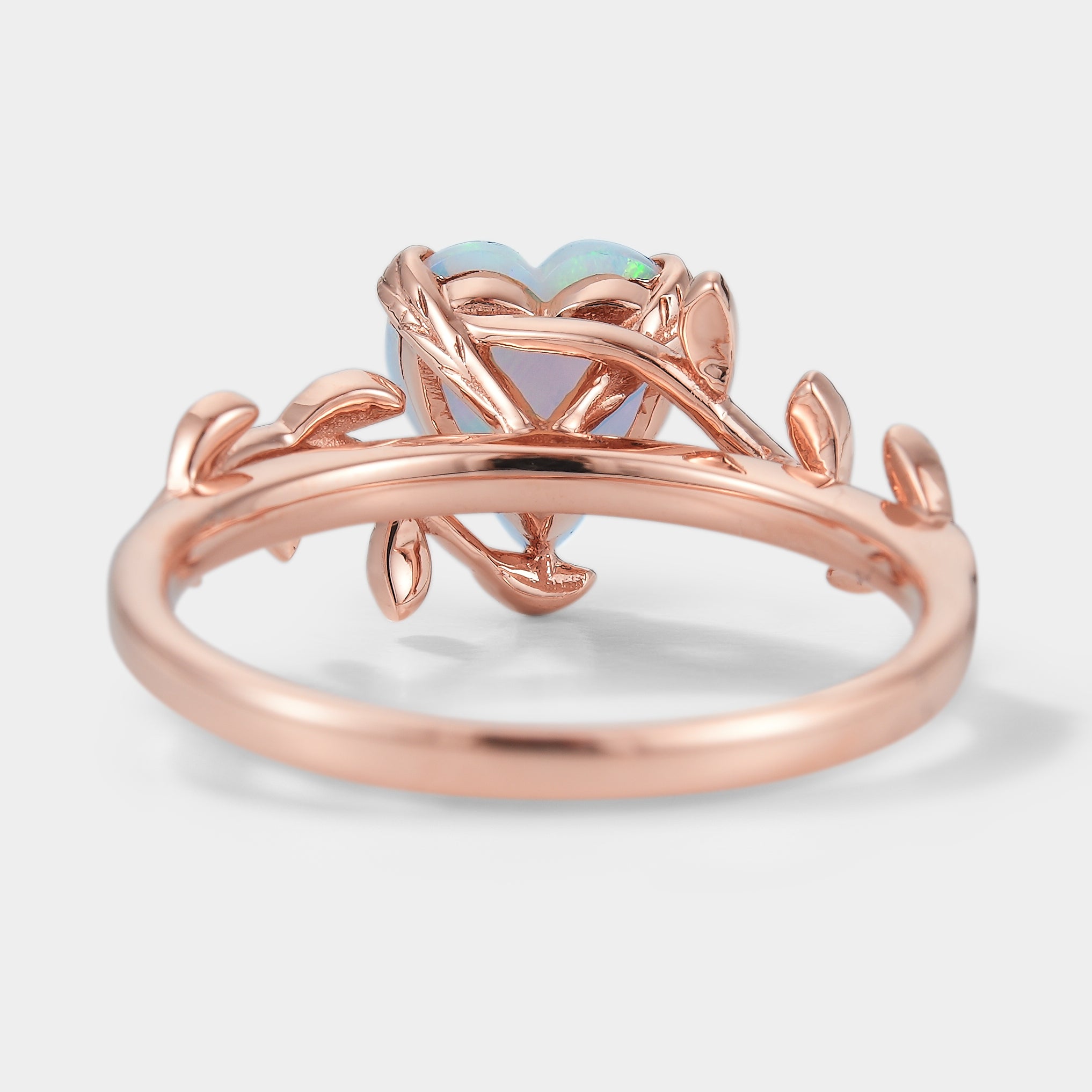 Rose gold heart opal engagement ring with leaf design