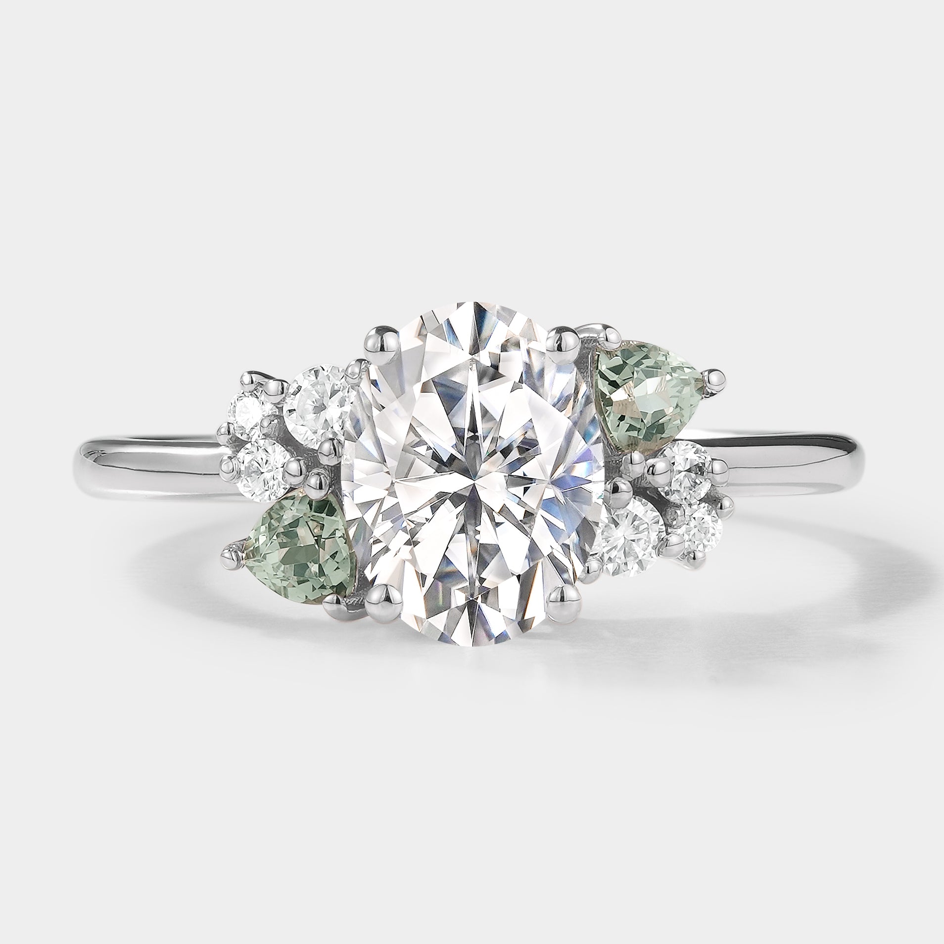 Oval cut moissanite engagement ring with cluster accents