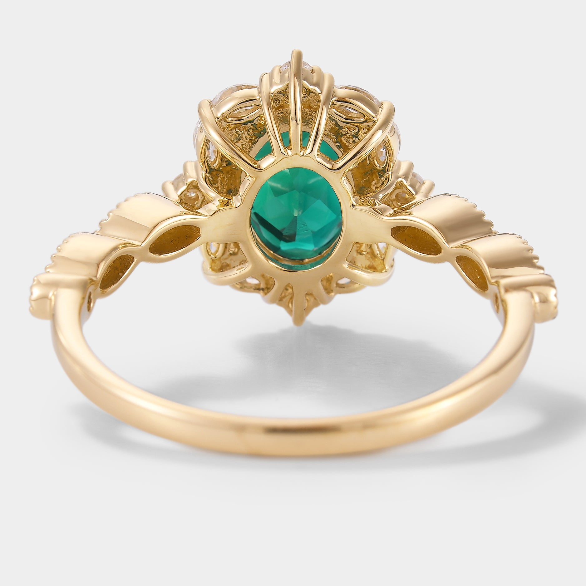 Detailed back view of emerald and moissanite engagement ring