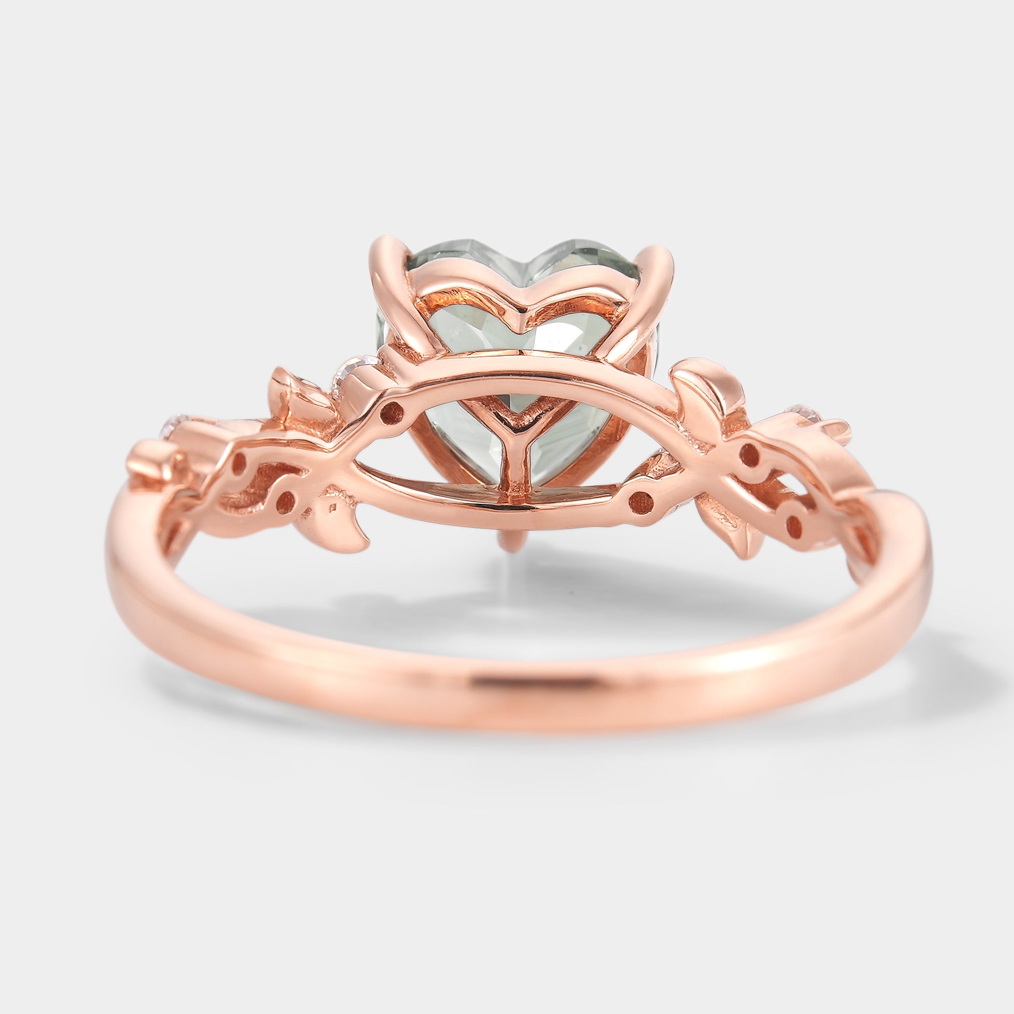 Rose gold engagement ring with heart-cut lab green sapphire and leaf details