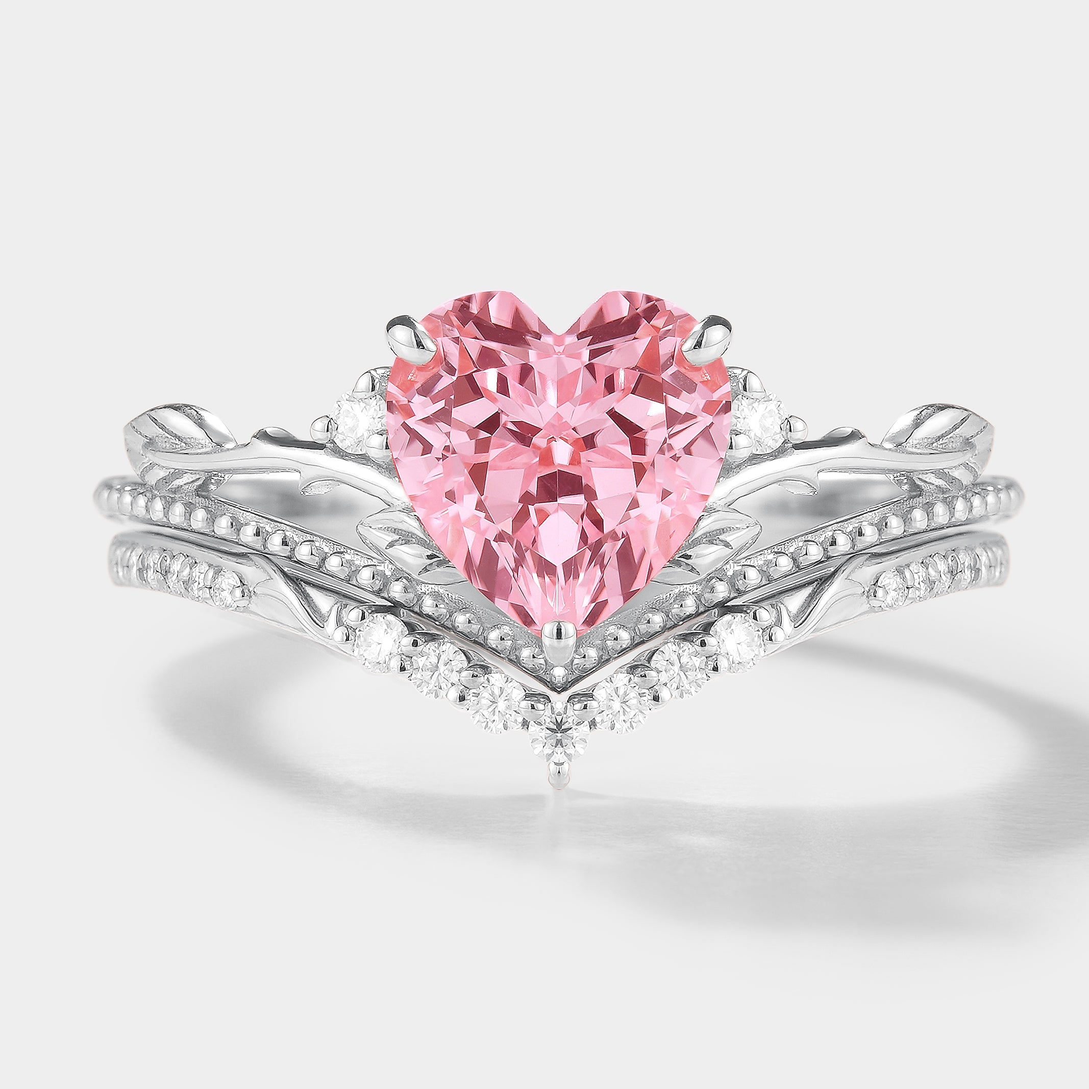 Heart-cut Padparadscha sapphire engagement ring set with leaf details