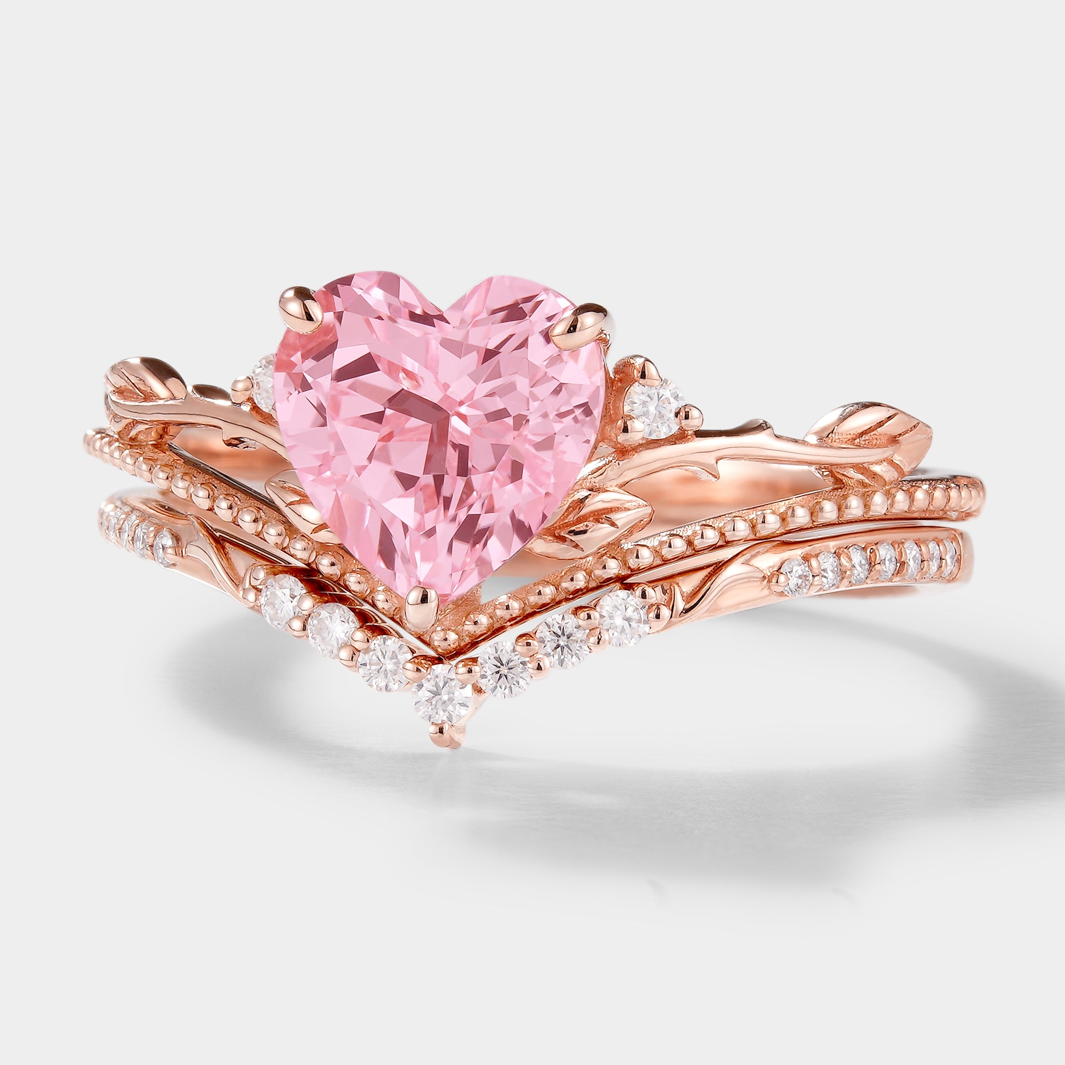 Rose gold heart-cut sapphire engagement ring set with leaf details