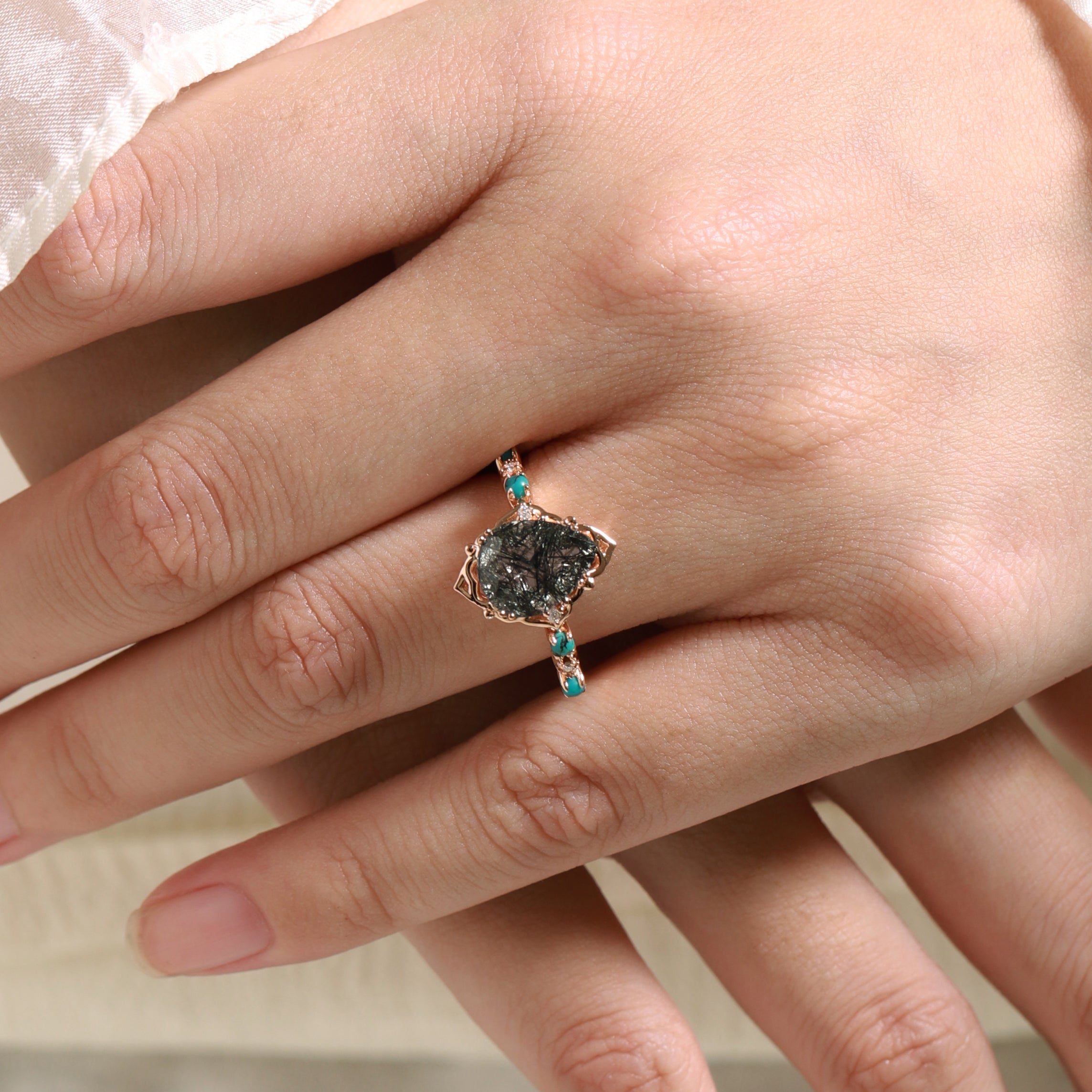 Vintage pear-cut black rutilated quartz engagement ring with turquoise accents in rose gold band.