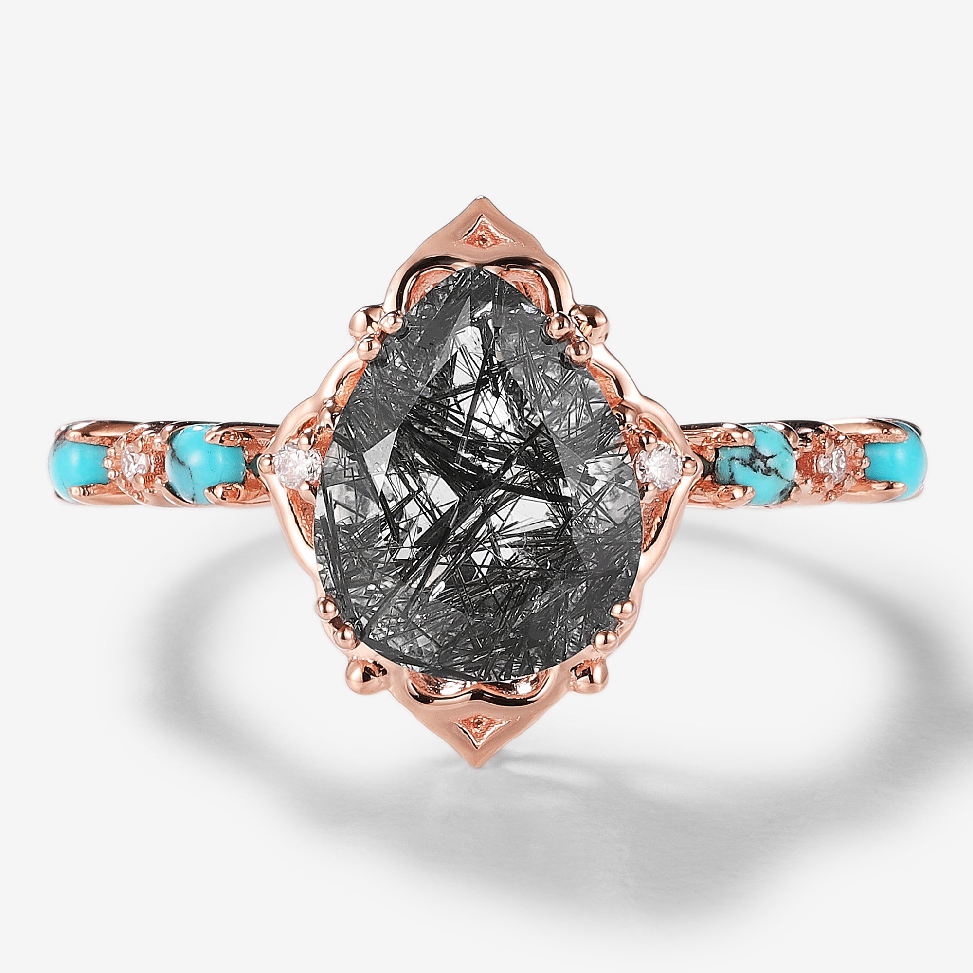 Vintage pear-cut black rutilated quartz engagement ring with turquoise accents, rose gold band, and moissanite accents