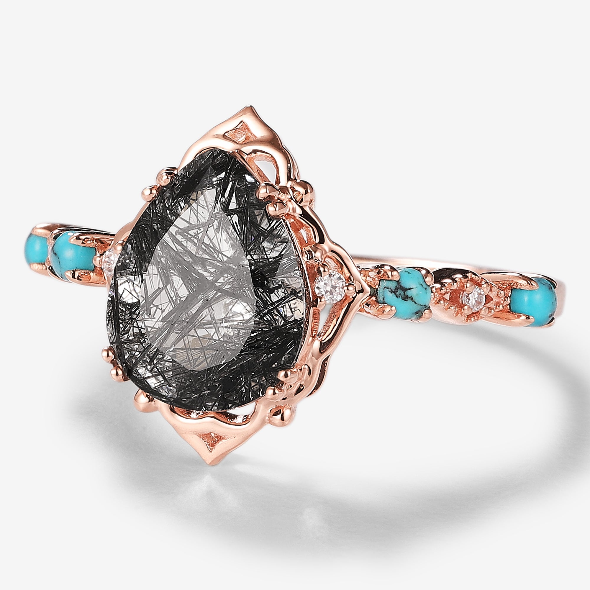 Vintage rose gold engagement ring with pear-cut black rutilated quartz, turquoise accents, and moissanite.