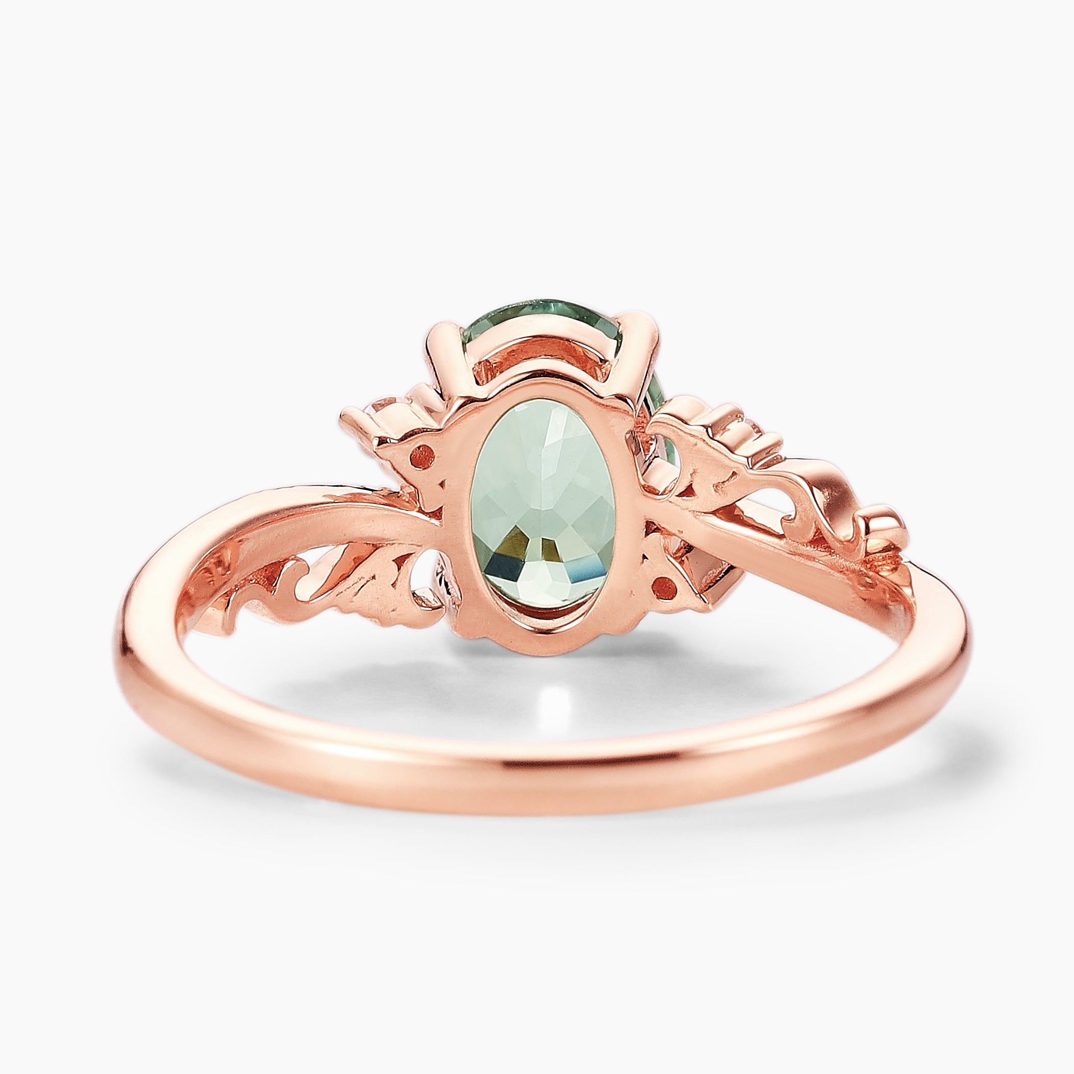 Oval green sapphire vintage engagement ring in rose gold with leaf-inspired design