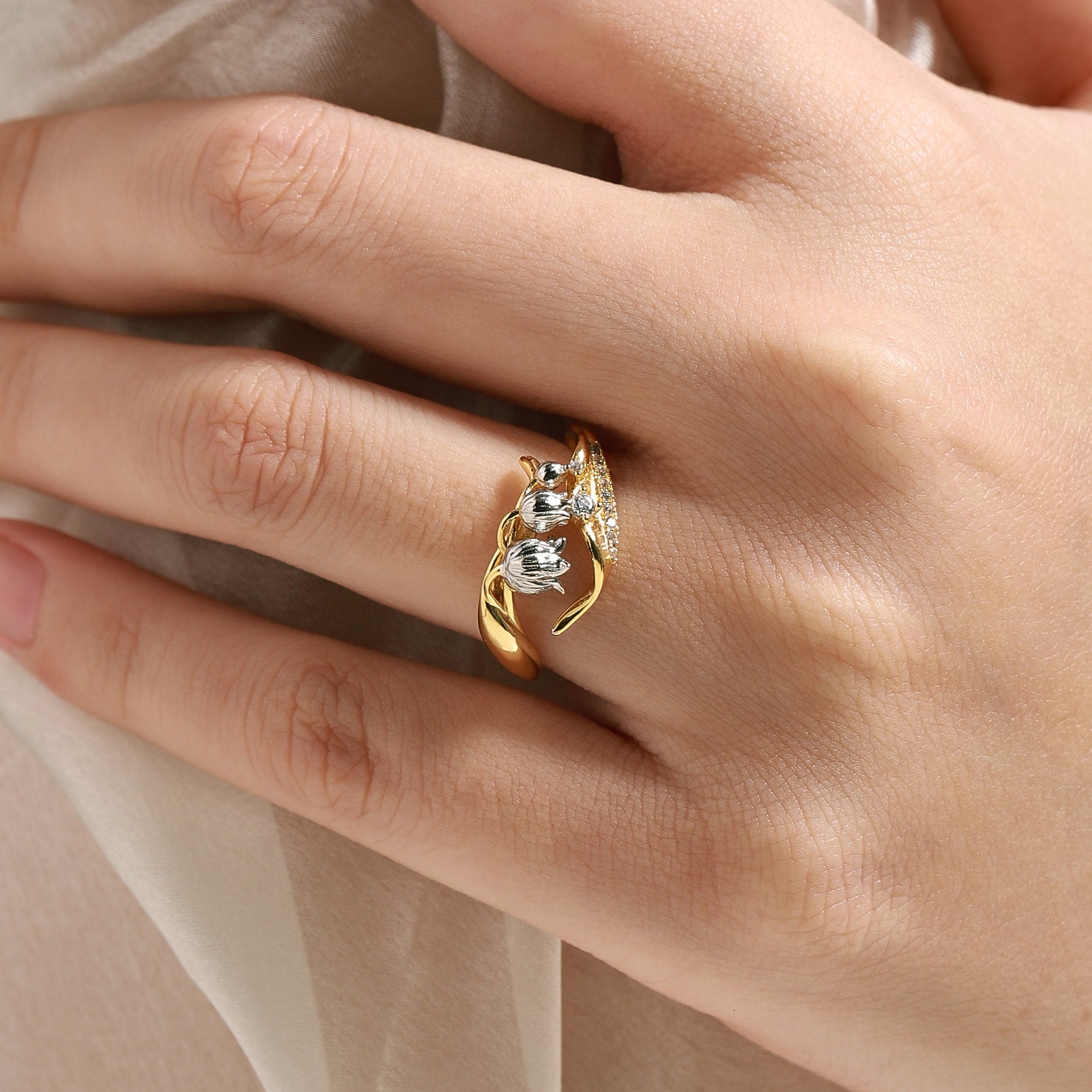 Woman wearing Lily of the Valley ring with moissanite