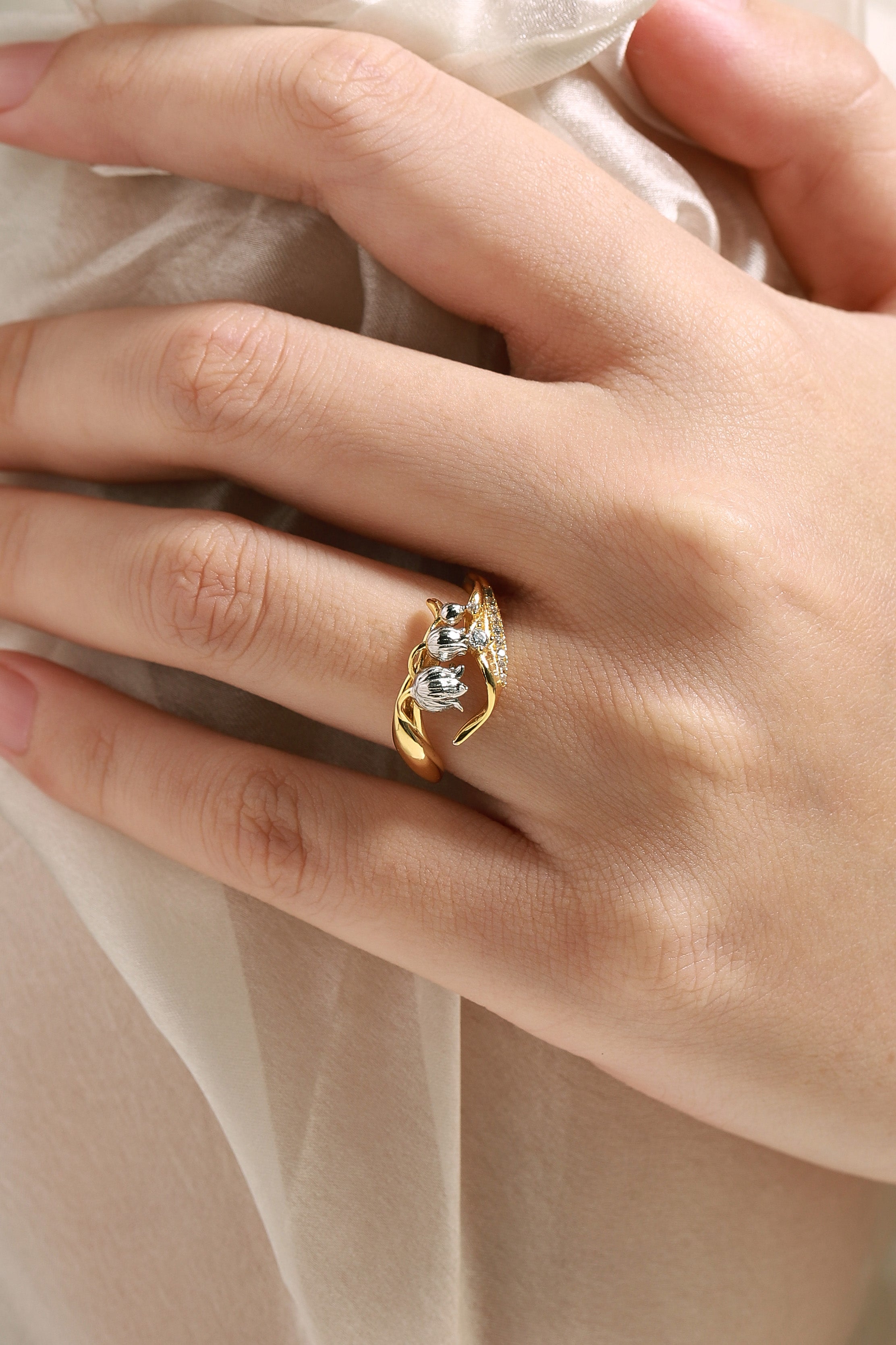 Woman wearing Lily of the Valley ring with moissanite