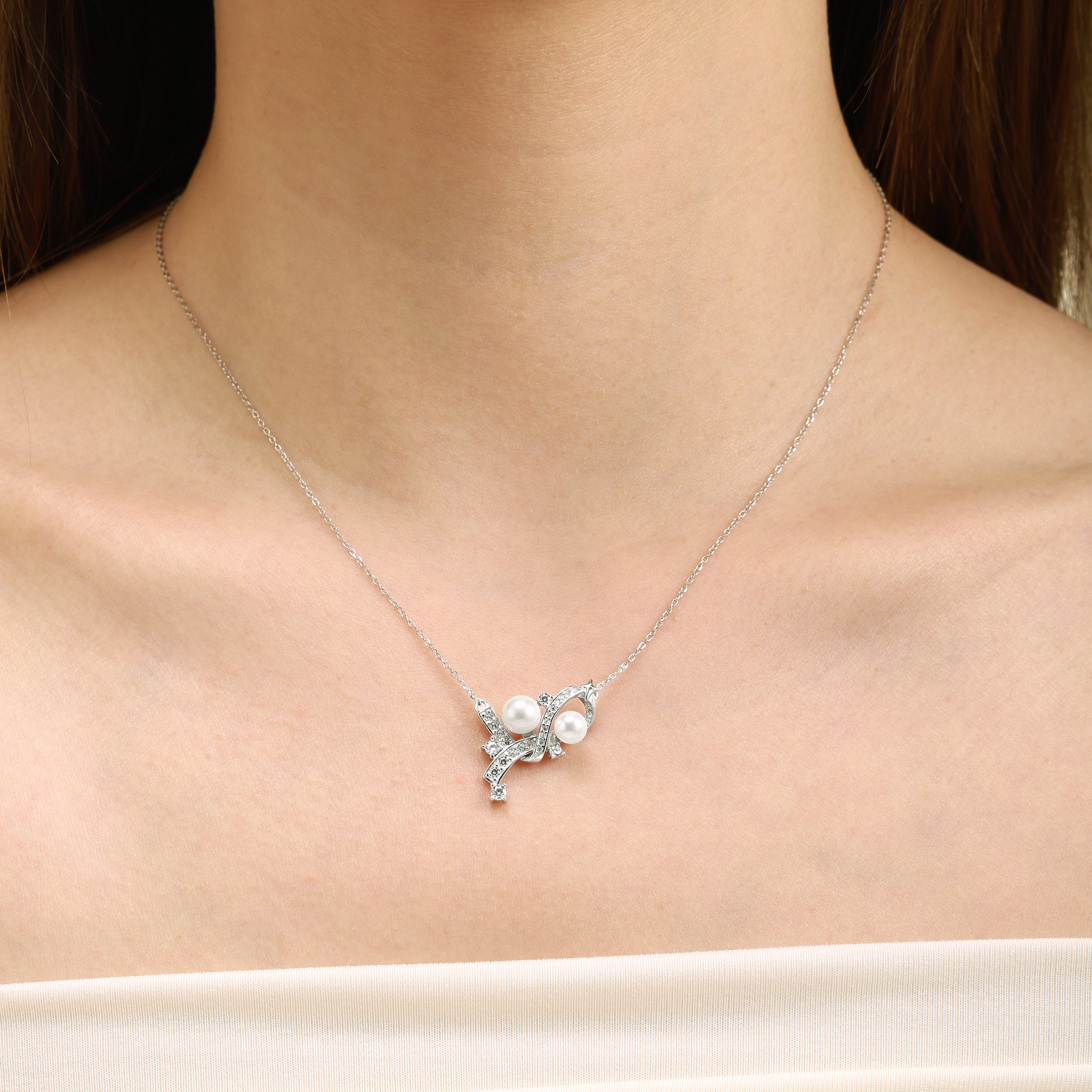 Gemini Zodiac Pearl Necklace on a woman's neck