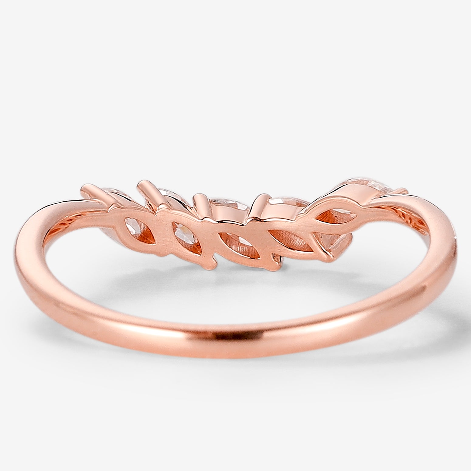 Rose gold moissanite leaf design wedding band. Features marquise cut stones and a delicate curved shape, perfect bridal set.