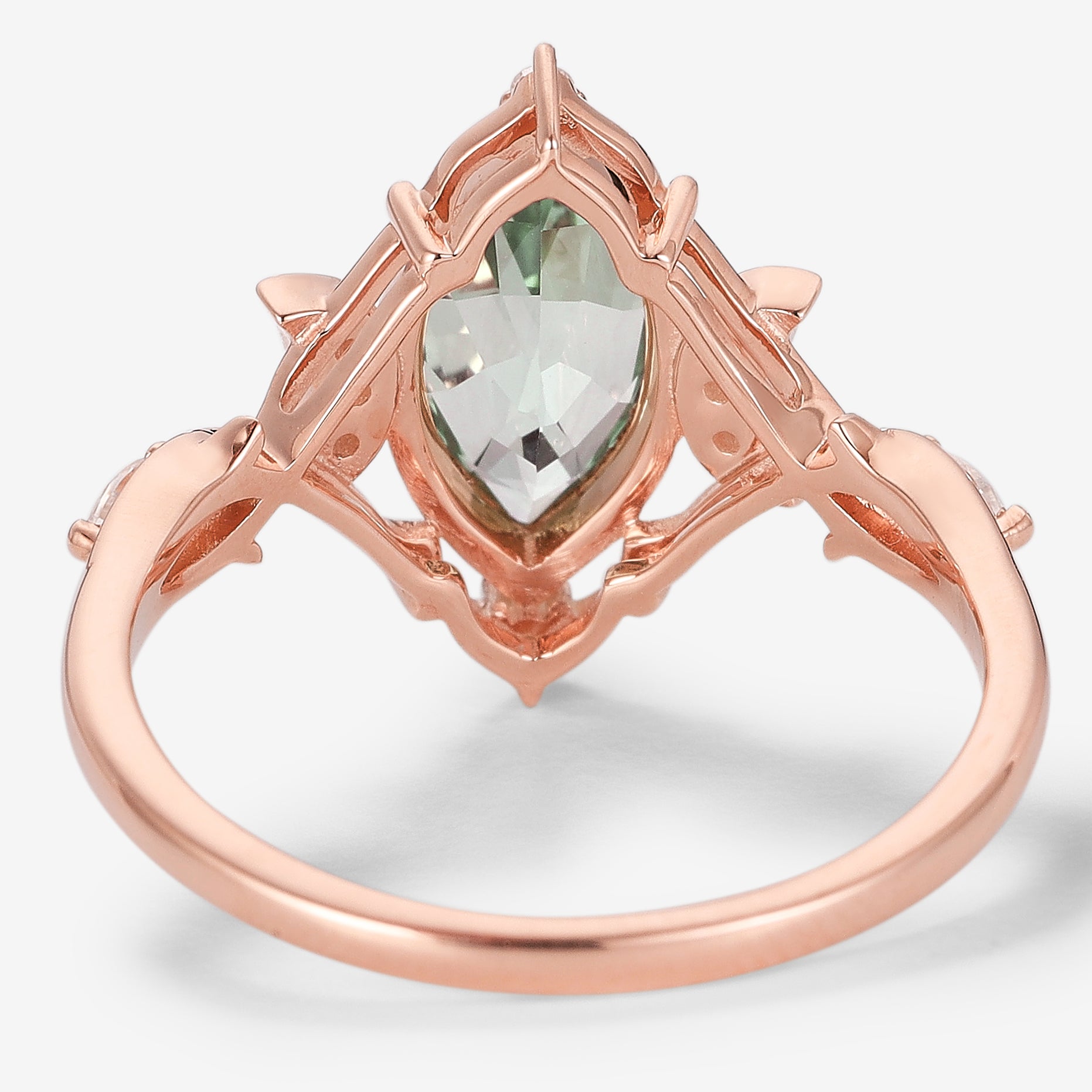 Rose gold marquise green sapphire engagement ring with moon and moissanite accents, vintage design.
