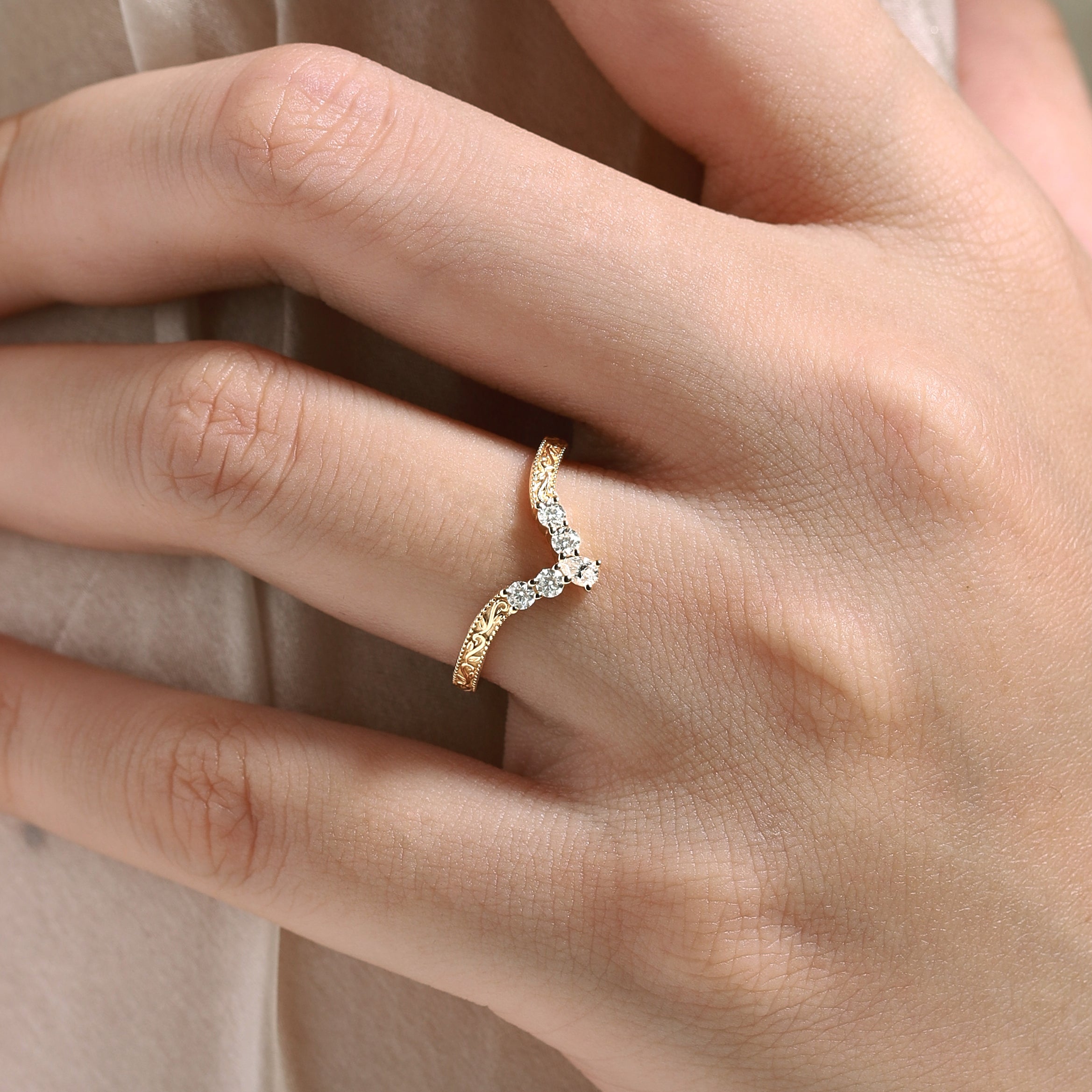 Vintage engraved wedding band with moissanite, gold ring on hand, bridal jewelry