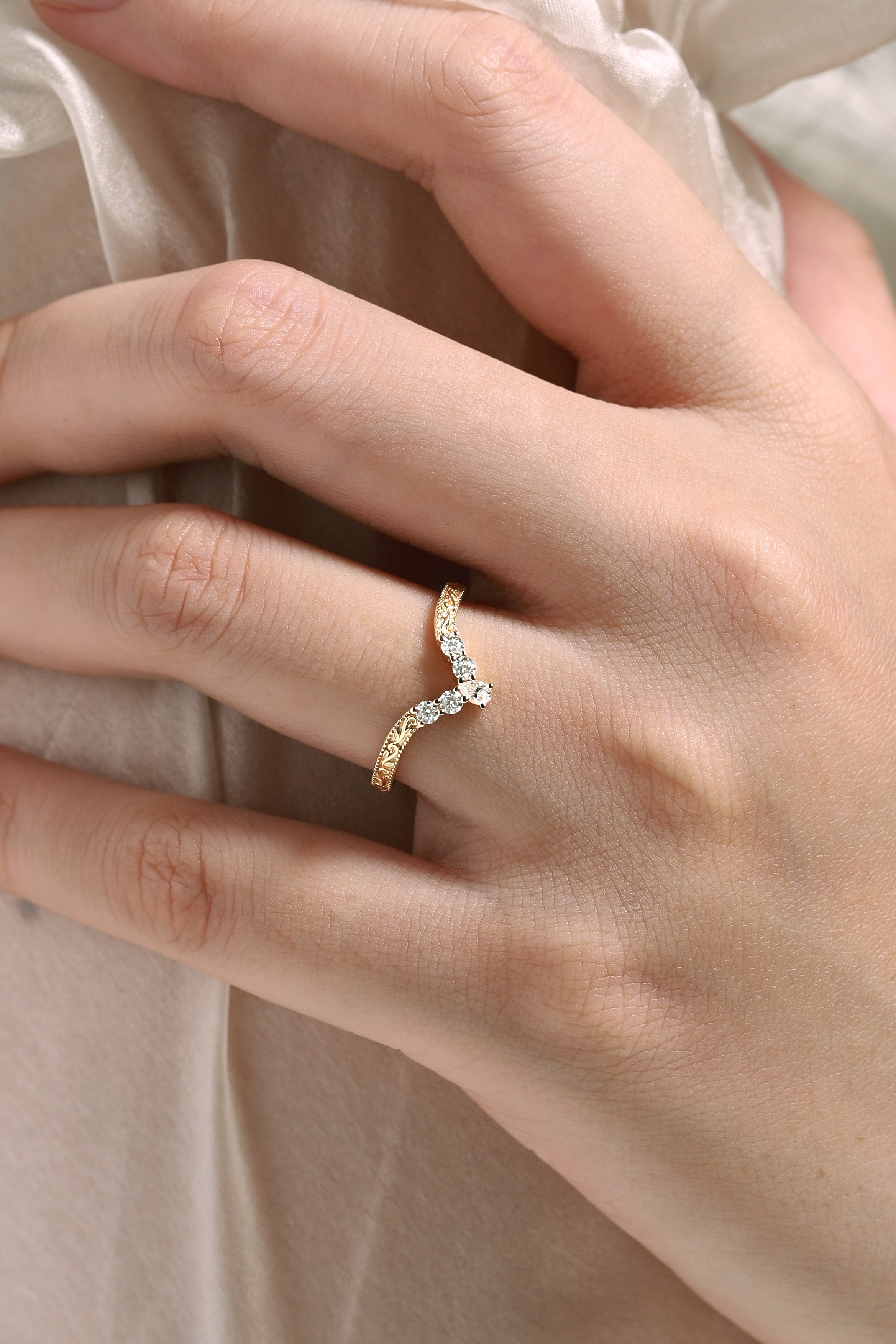 Vintage engraved wedding band with moissanite, gold ring on hand, bridal jewelry