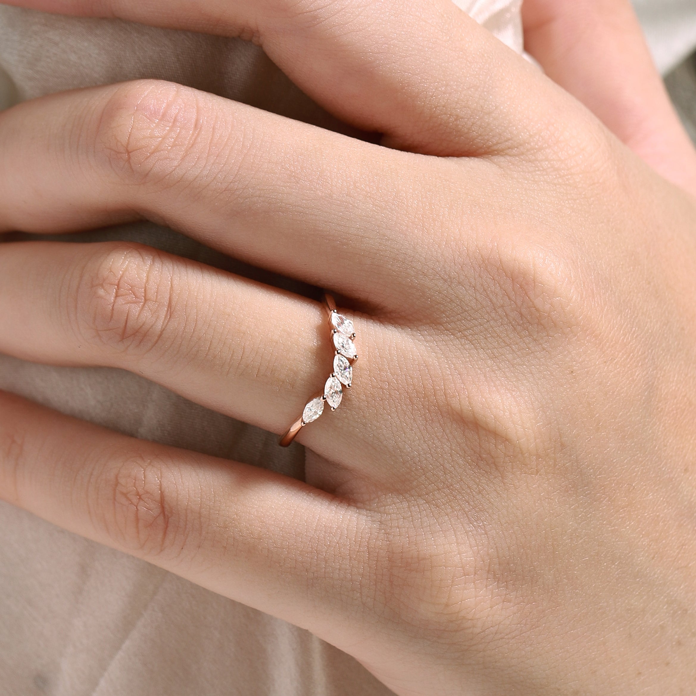 Rose gold wedding band with marquise moissanite stones, perfect for engagement. Shop wedding rings.