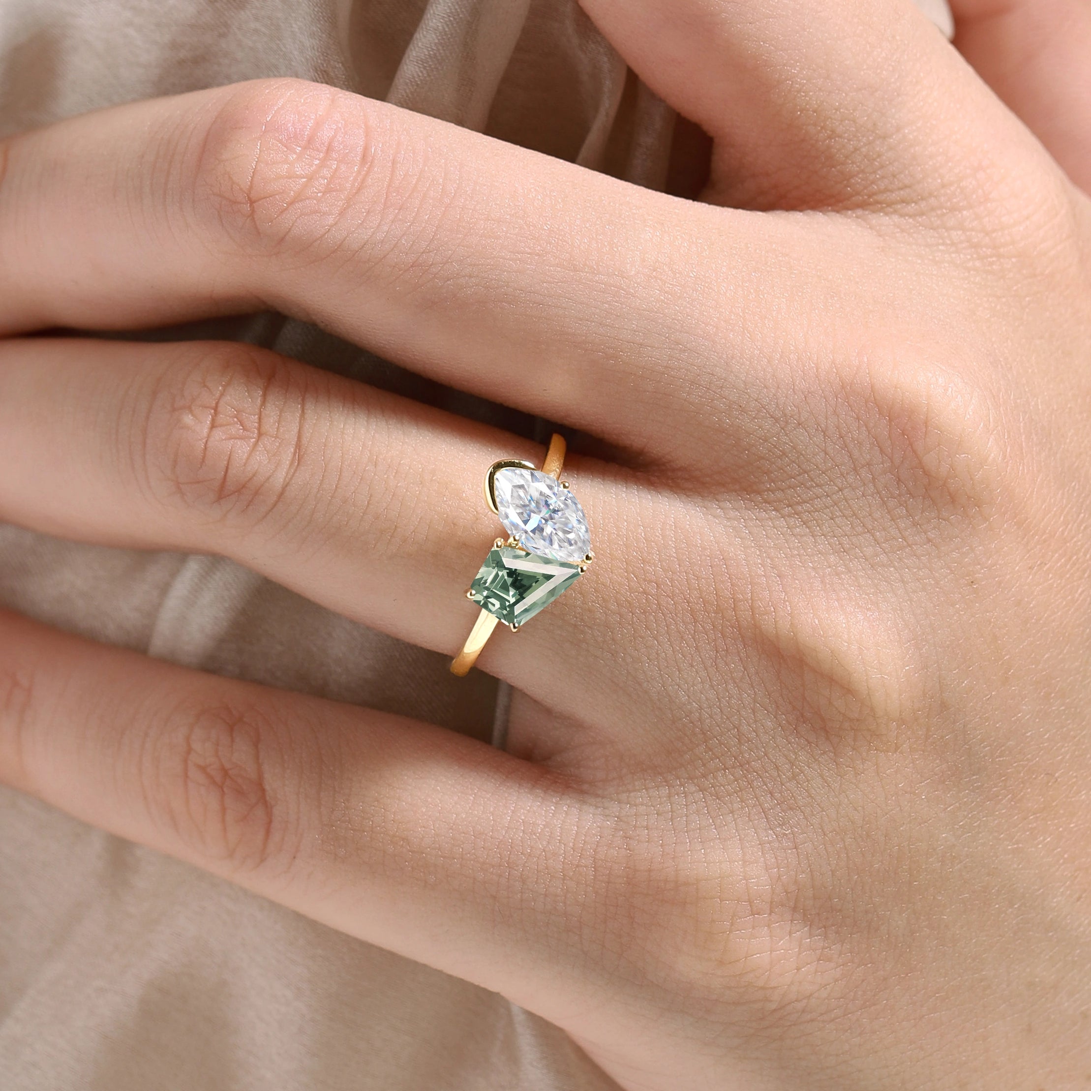 Engagement ring with marquise moissanite and kite-cut green sapphire in yellow gold, Lahela Jewelry.