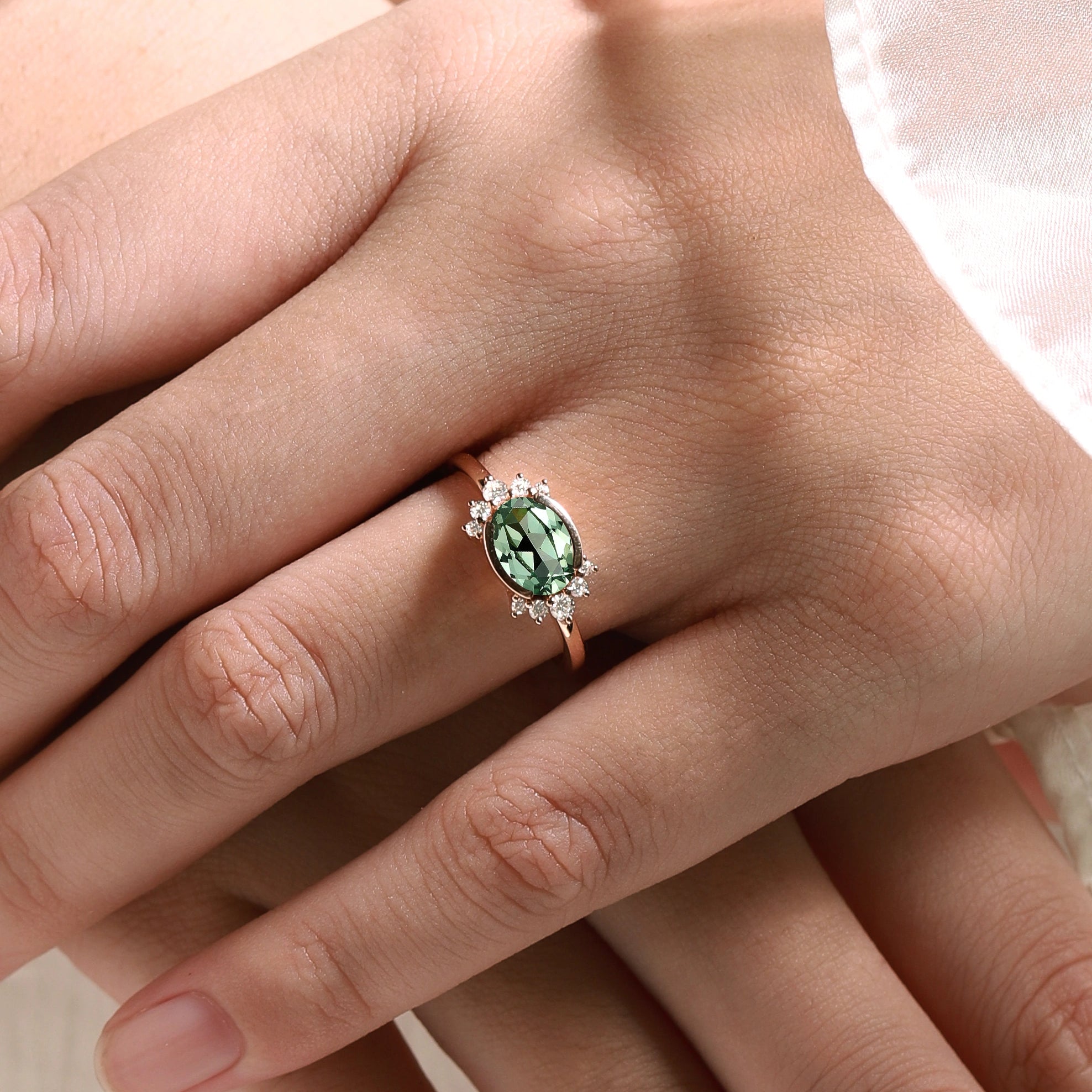Rose gold engagement ring with oval green sapphire and moissanite accents. Wedding ring.