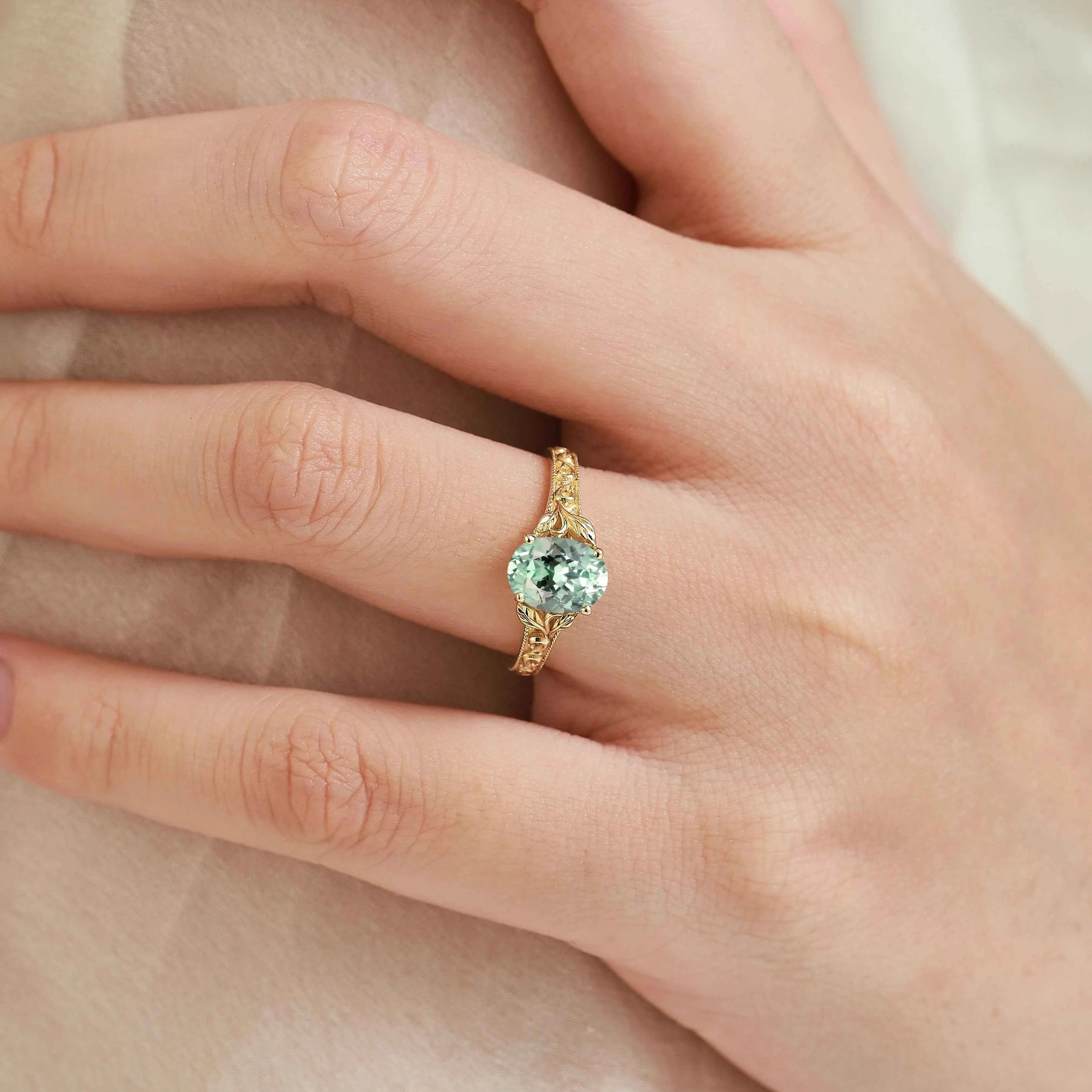 Oval-Cut Green Sapphire Engagement Ring with Leaf-Embraced Band