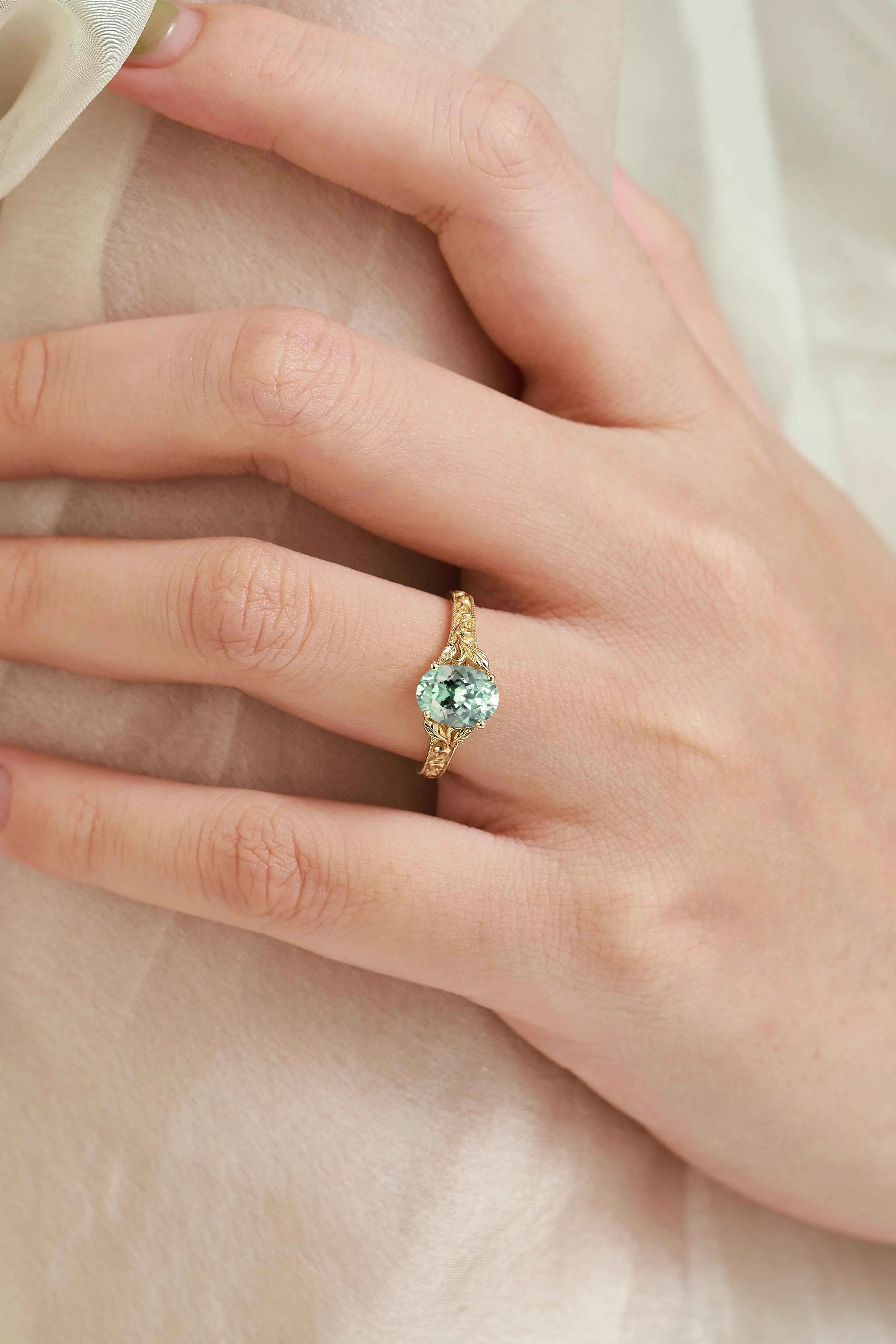 Oval-Cut Green Sapphire Engagement Ring with Leaf-Embraced Band