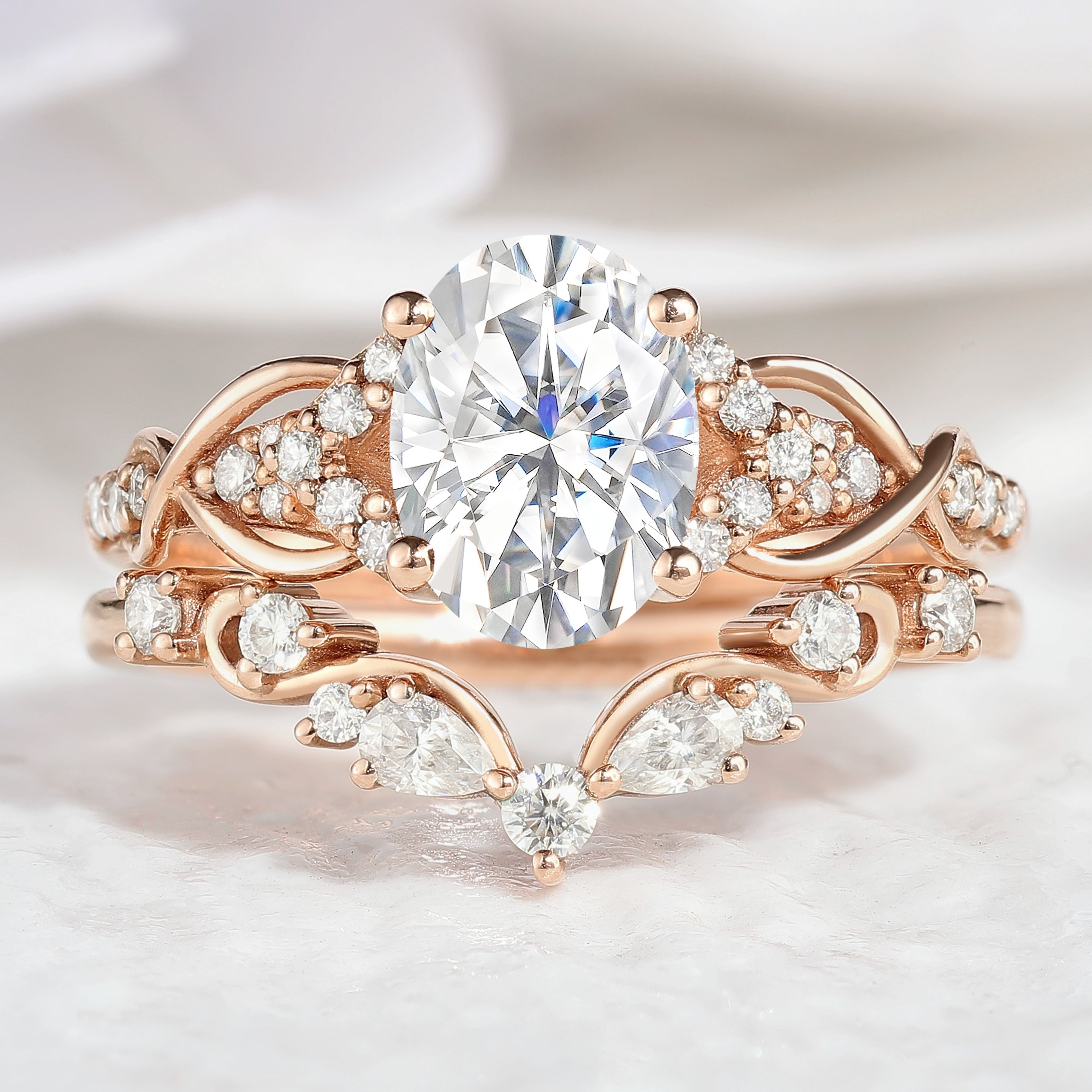 Oval cut moissanite engagement ring with curved band, rose gold