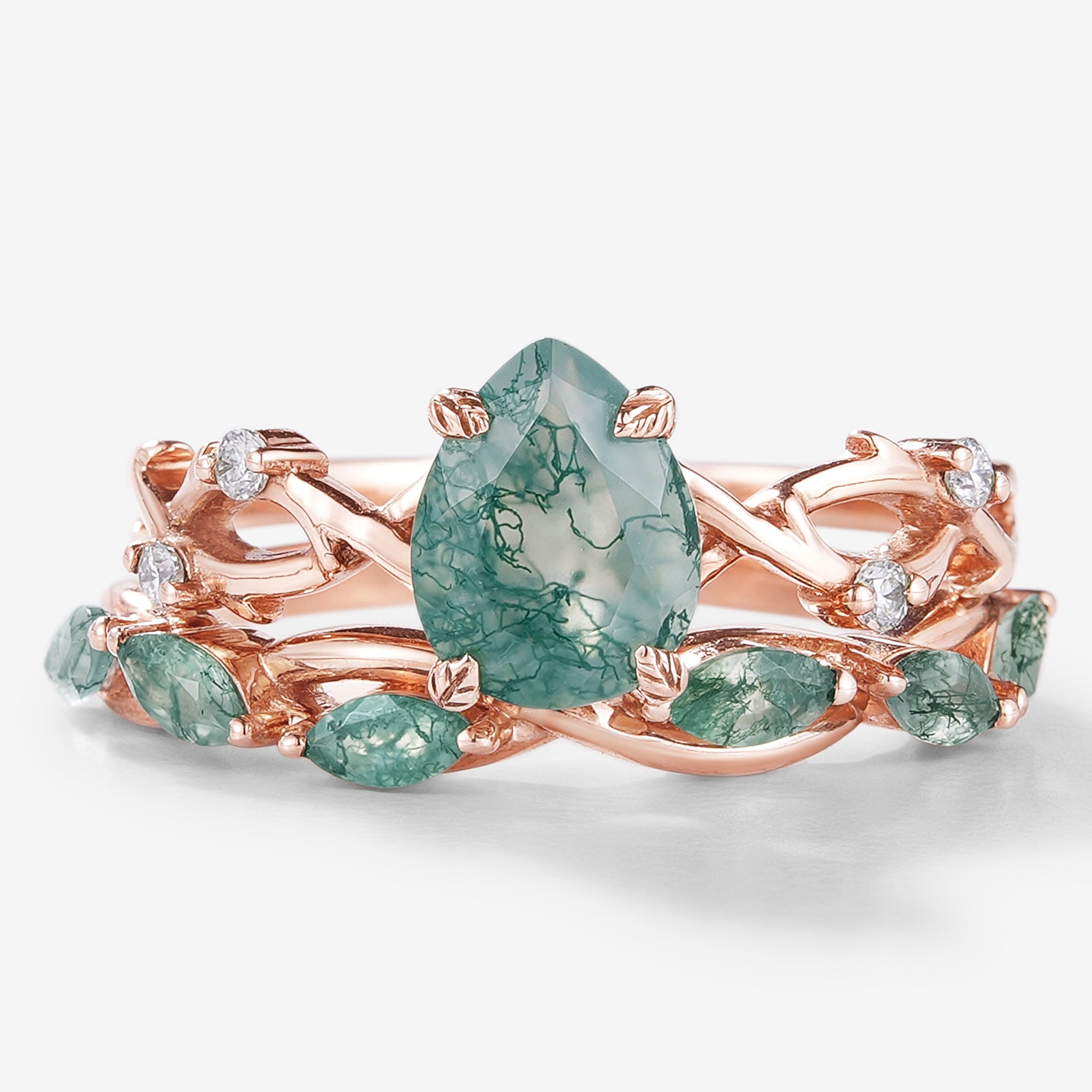 2-piece Moss Agate engagement ring set with pear-cut center stone and straight wedding band in rose gold. Bridal ring set.