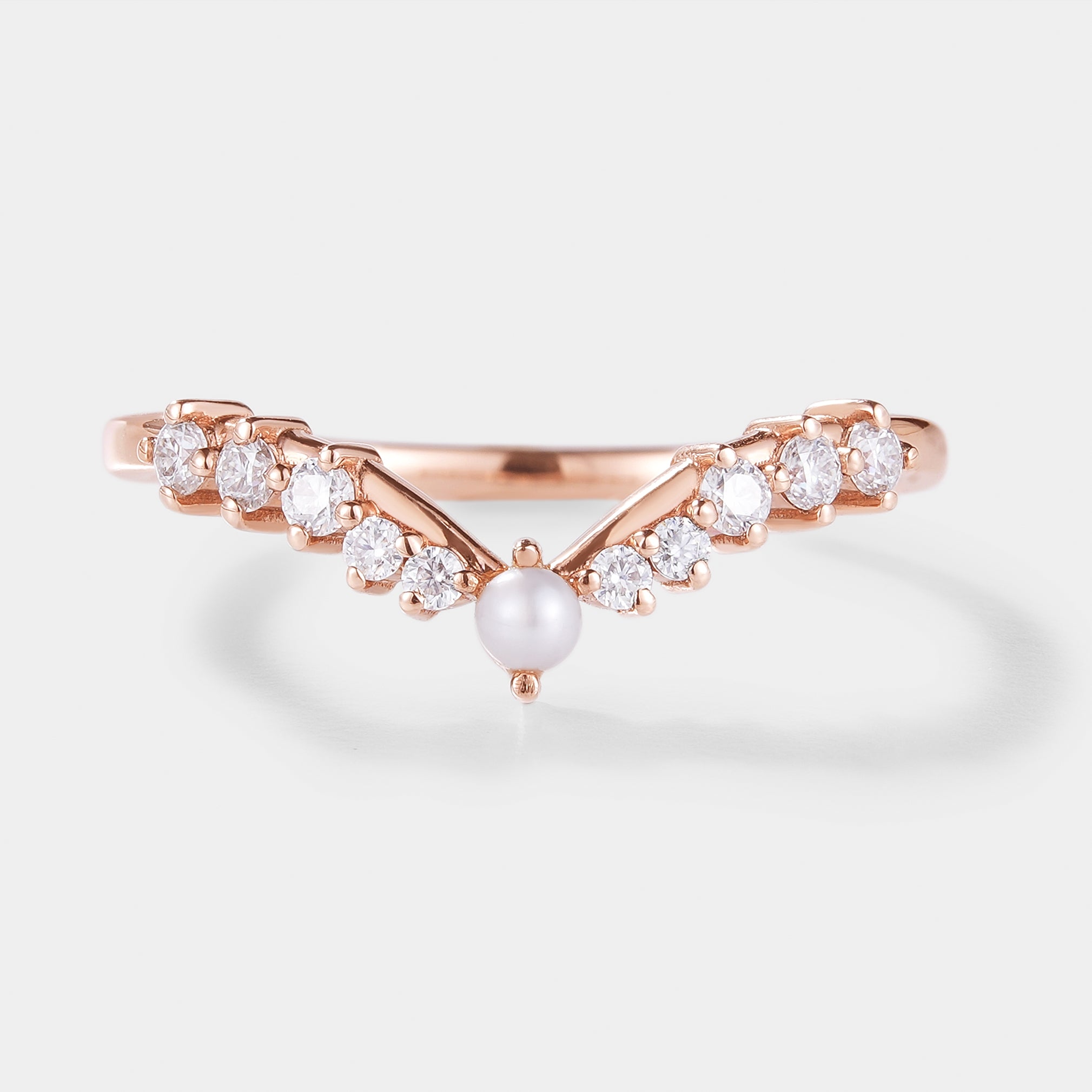 Curved wedding band with pearl and moissanite accents in rose gold. Bridal set ring.