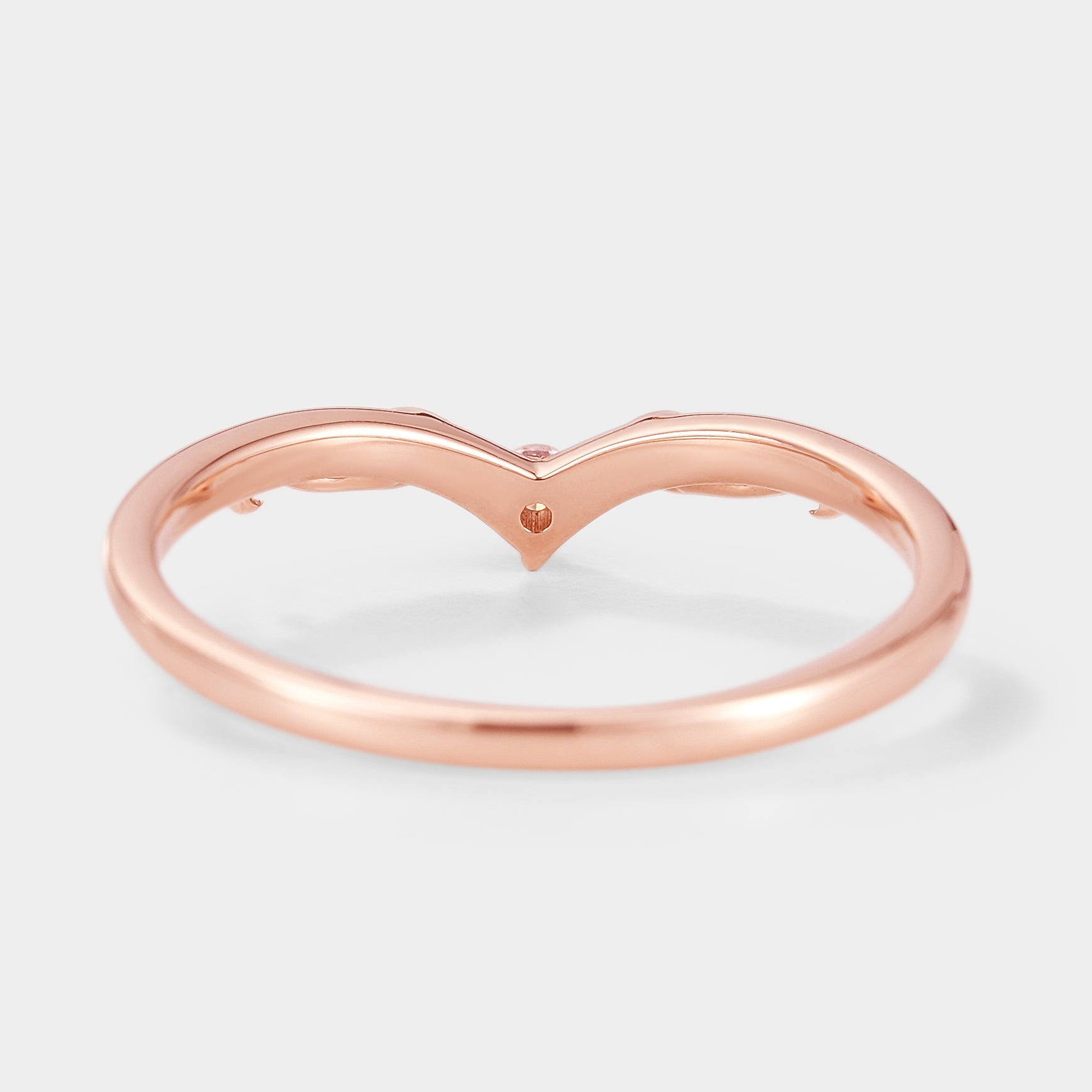 Rose gold V-shaped wedding band with moissanite