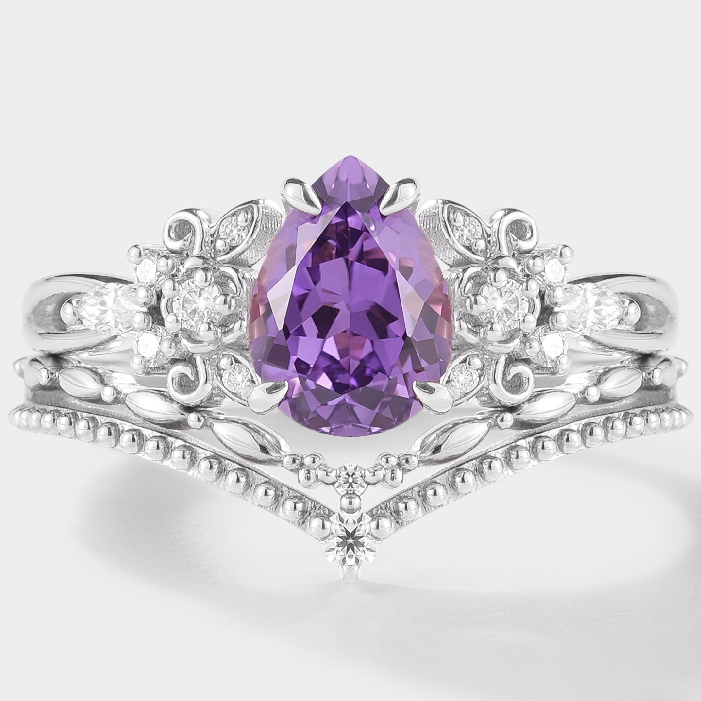 Nature-inspired purple sapphire engagement ring set with floral details