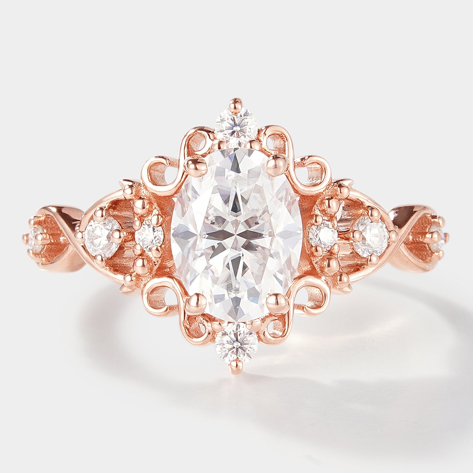 Vintage oval cut moissanite engagement ring in rose gold. Classic elegance.