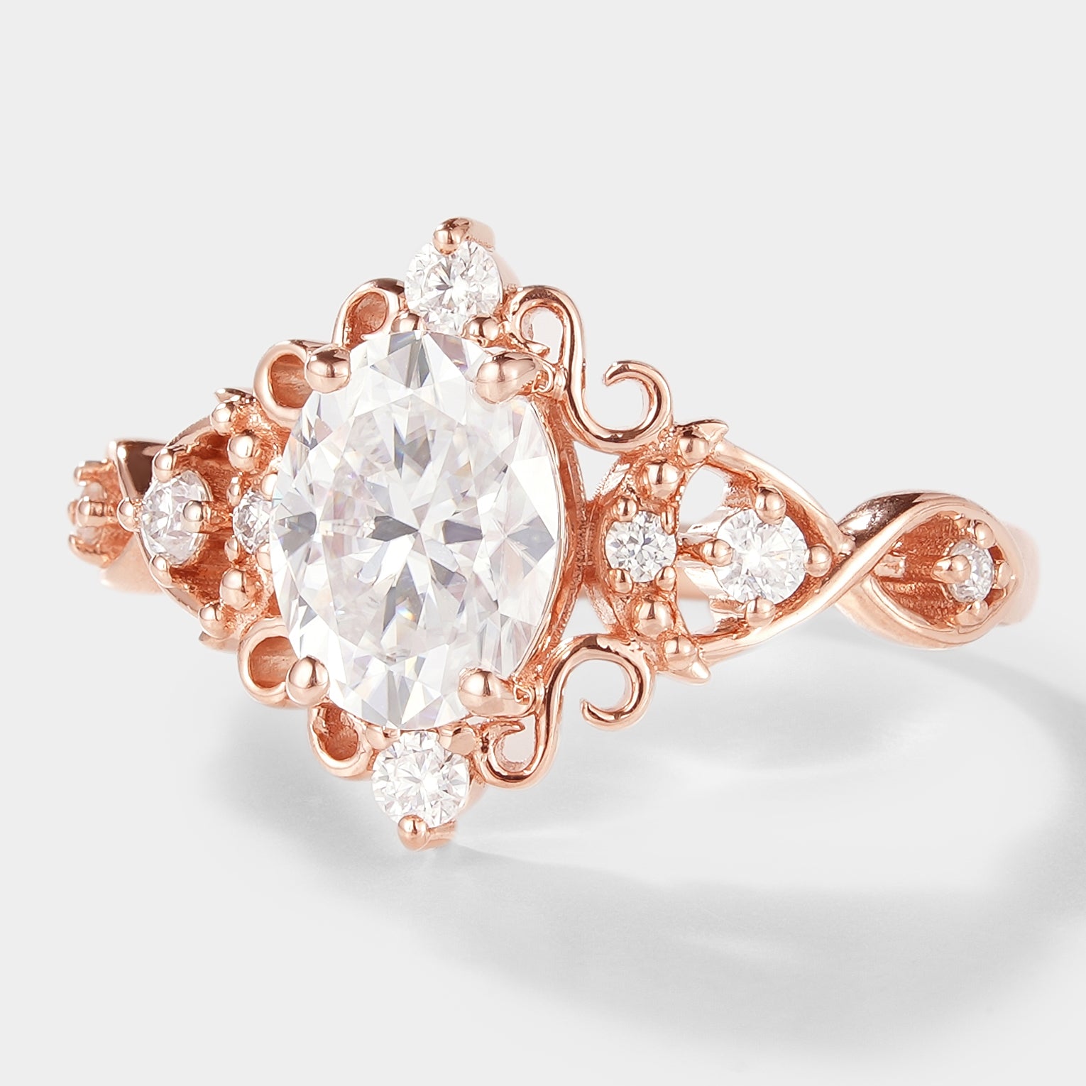 Rose gold vintage oval moissanite engagement ring. Classic design with halo and accent stones, bridal jewelry.