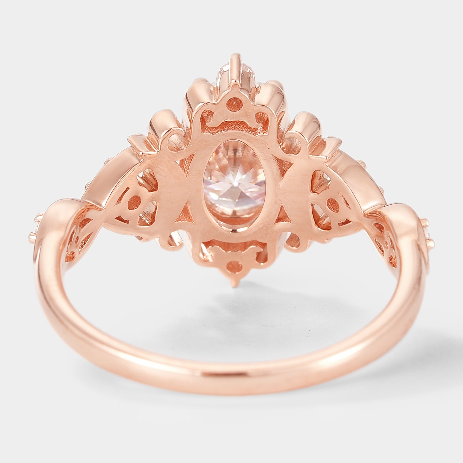 Rose gold vintage oval moissanite engagement ring. Bridal jewelry with unique details.