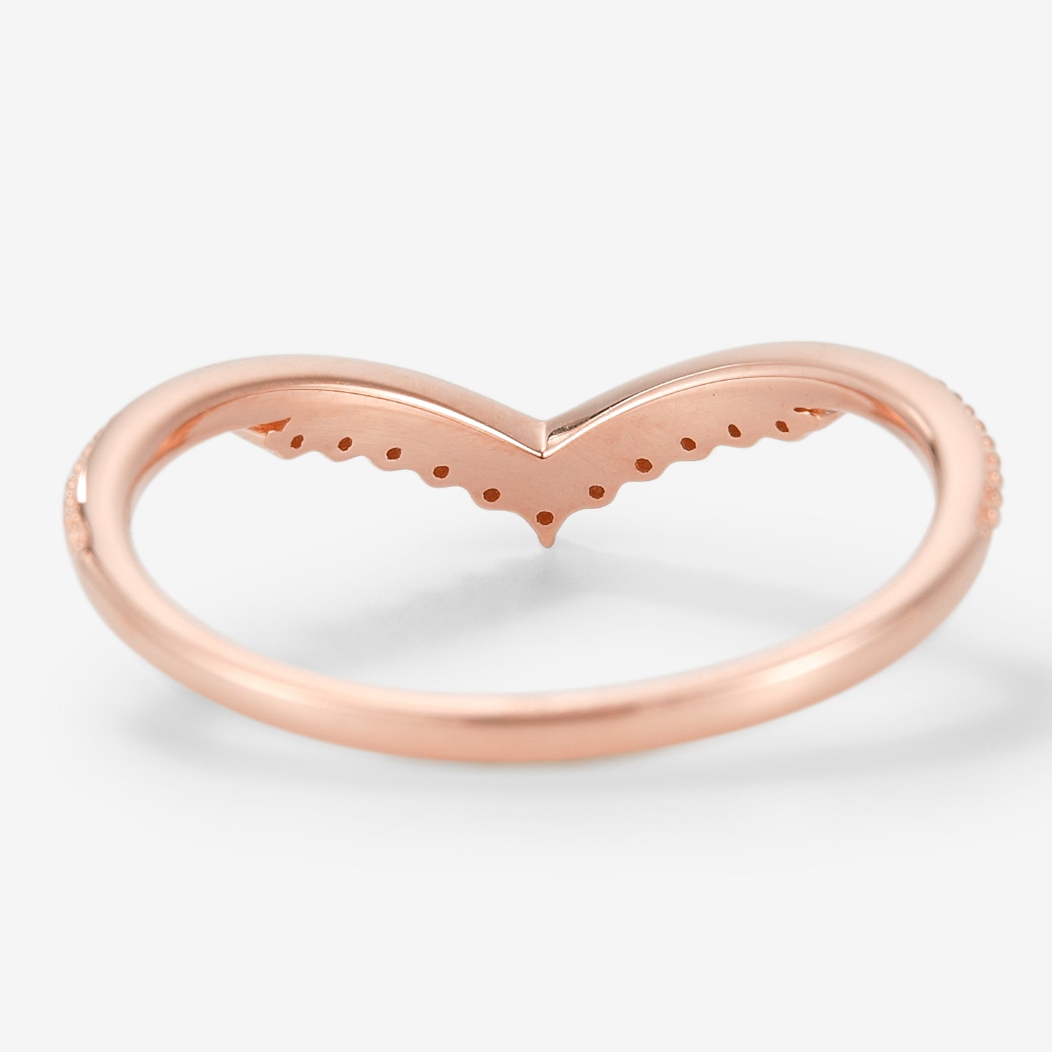 Rose gold moissanite V-shaped wedding band with milgrain detailing.