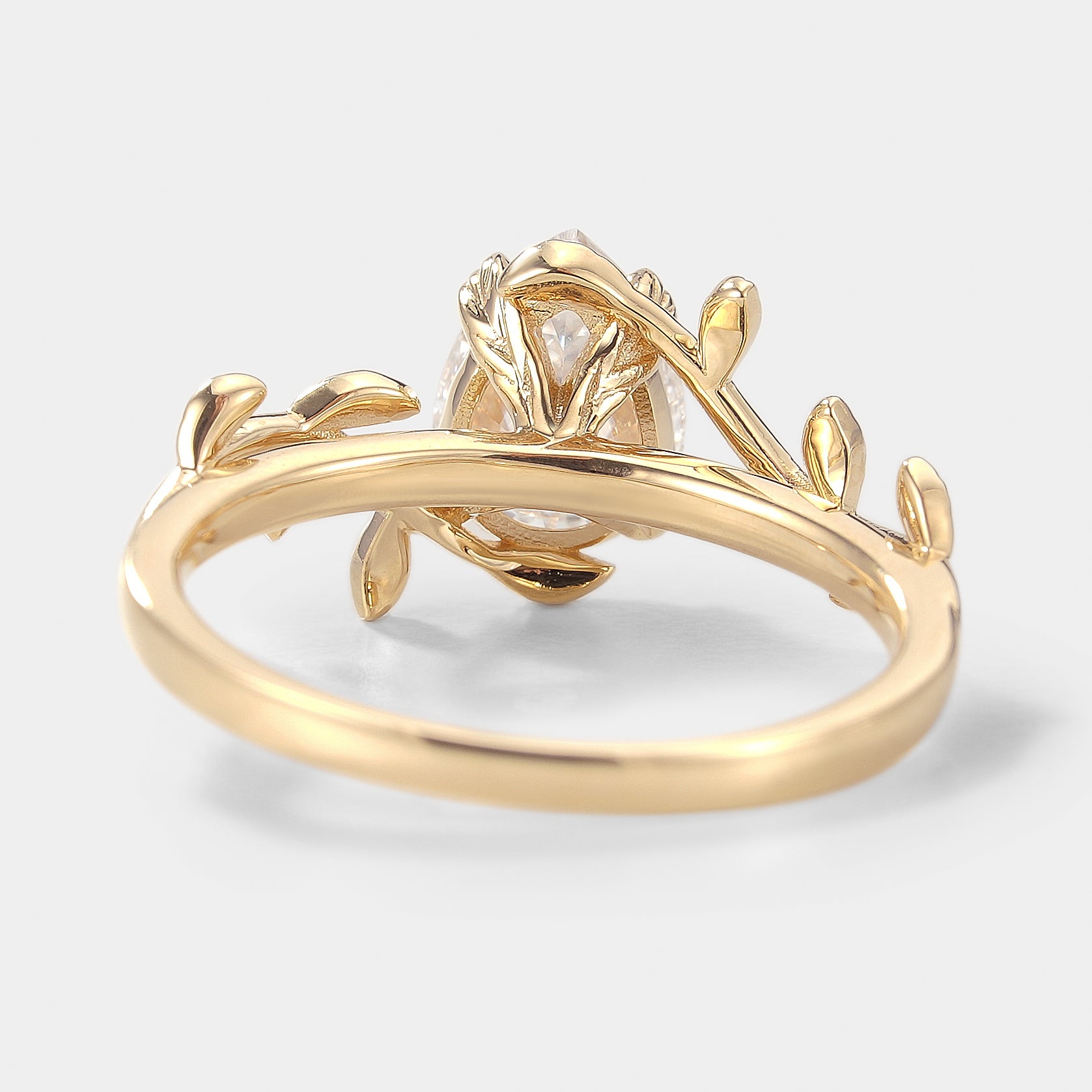 Nature-inspired engagement ring with pear cut moissanite and leaf band