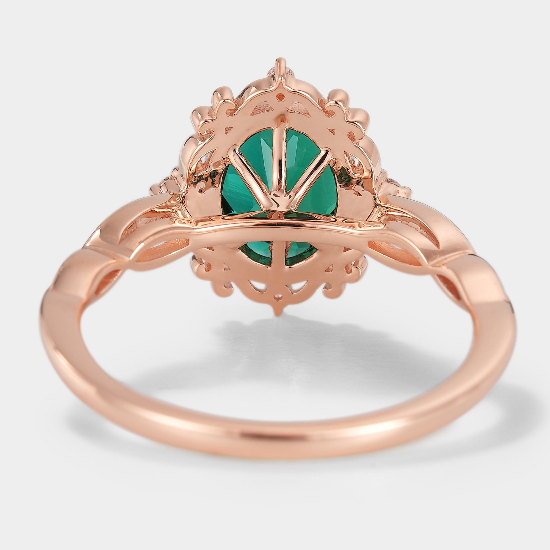 Vintage rose gold lab grown emerald engagement ring, oval cut with intricate filigree detailing