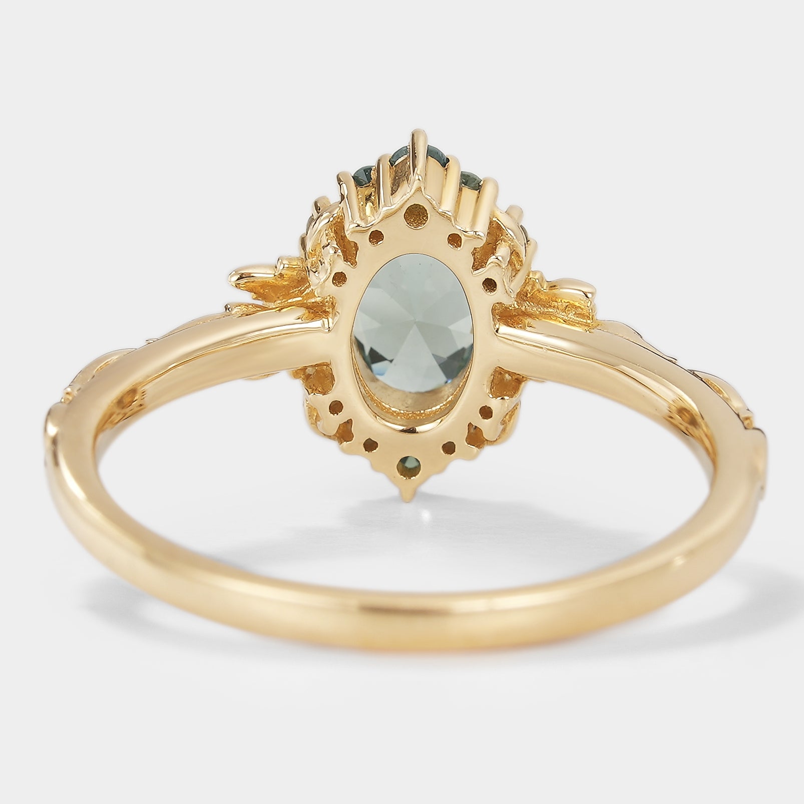 Back view of Saphira oval green sapphire engagement ring with leaf detailing in gold, bridal jewelry