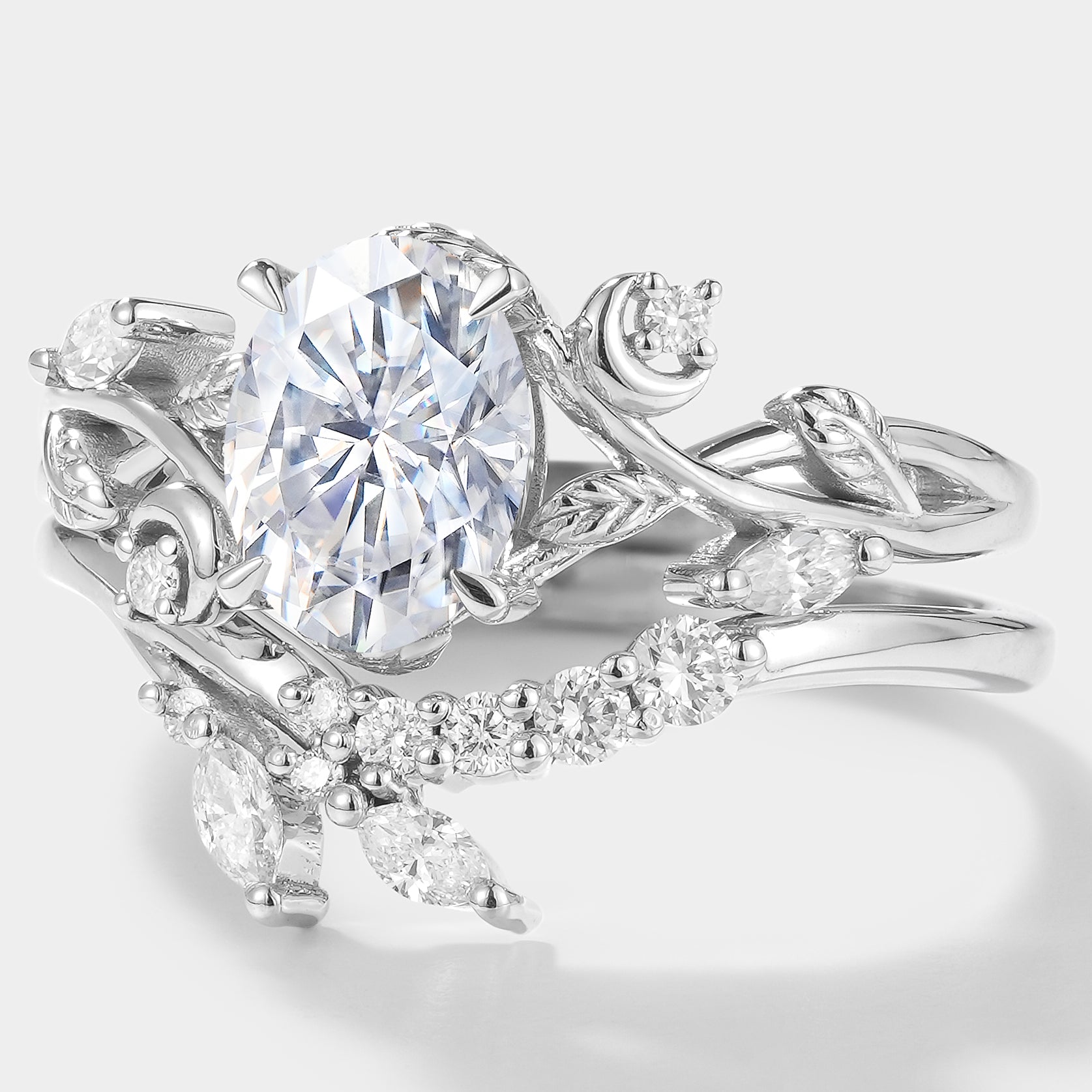 Nature-inspired oval moissanite engagement ring set with leaf design