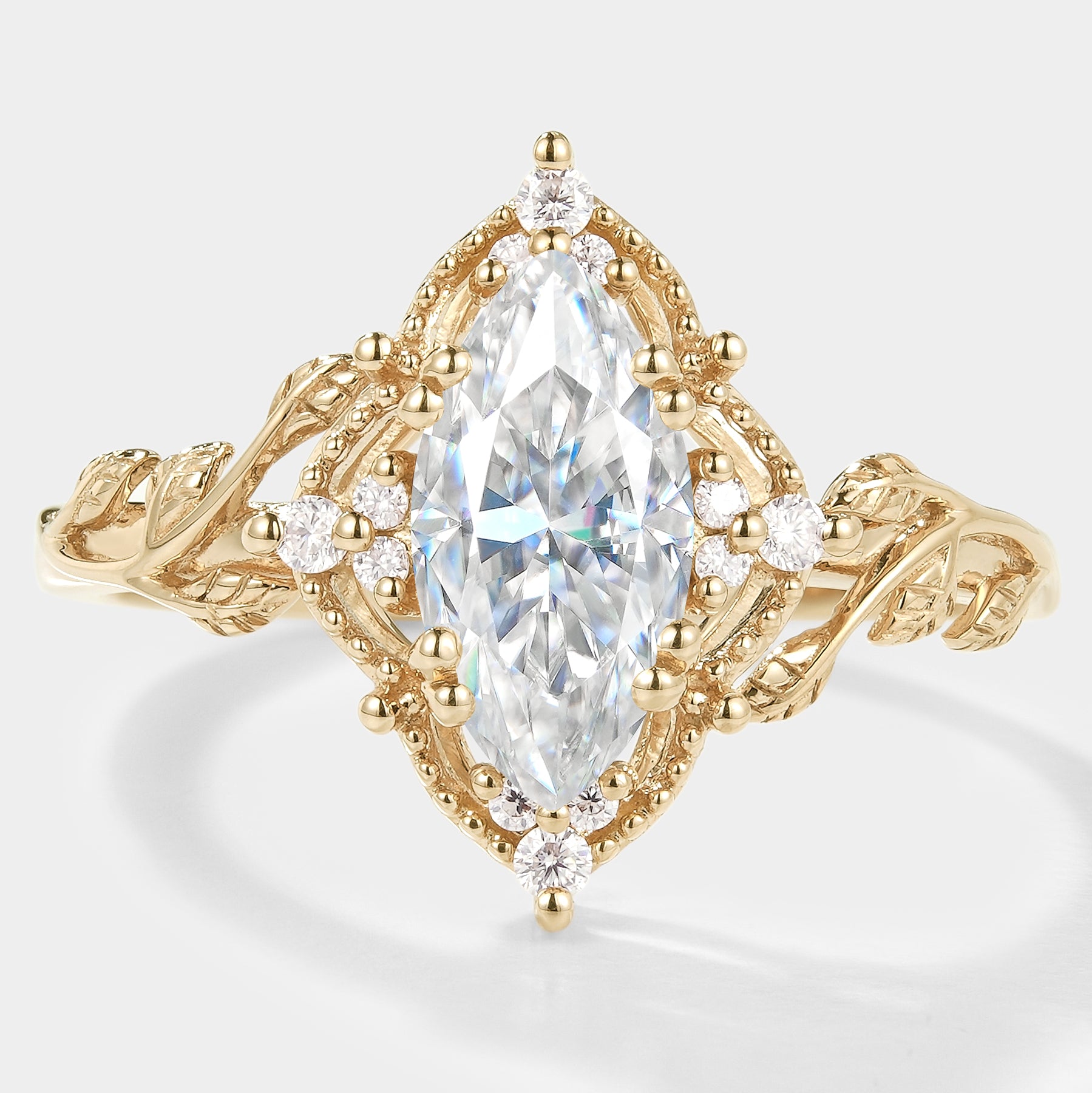 Nature-inspired marquise moissanite engagement ring with leaf detail