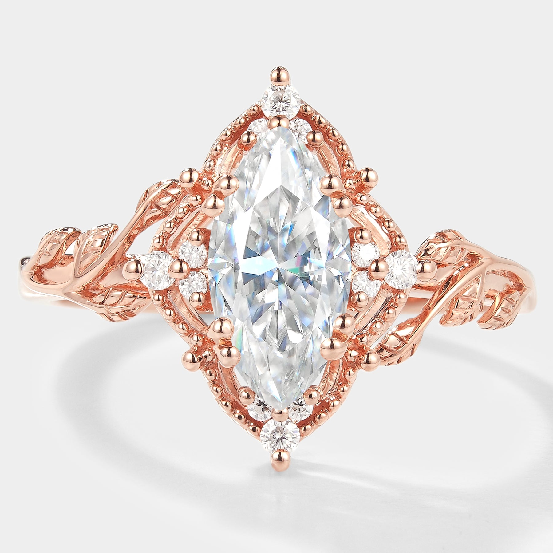 Marquise cut moissanite engagement ring with leaf design and rose gold band