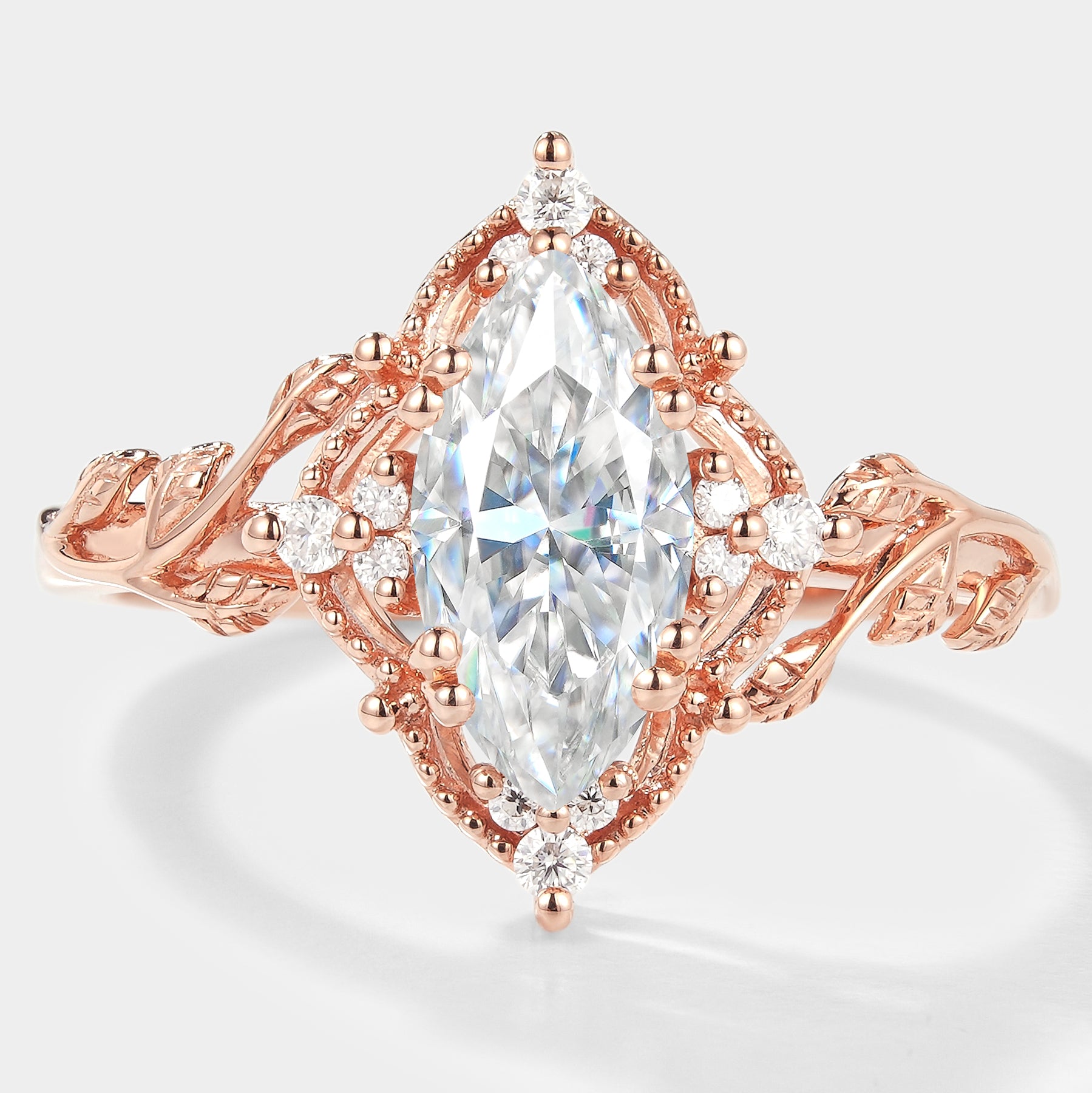 Marquise cut moissanite engagement ring with leaf design and rose gold band