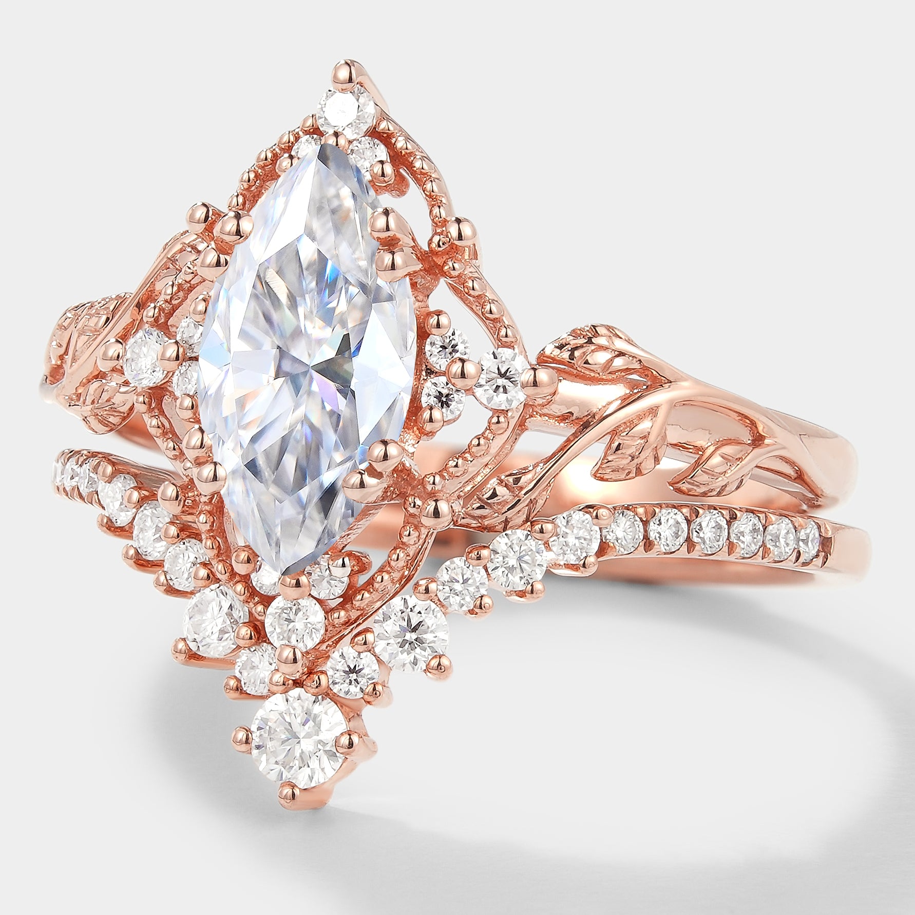 Rose gold marquise moissanite engagement ring set with leaf design
