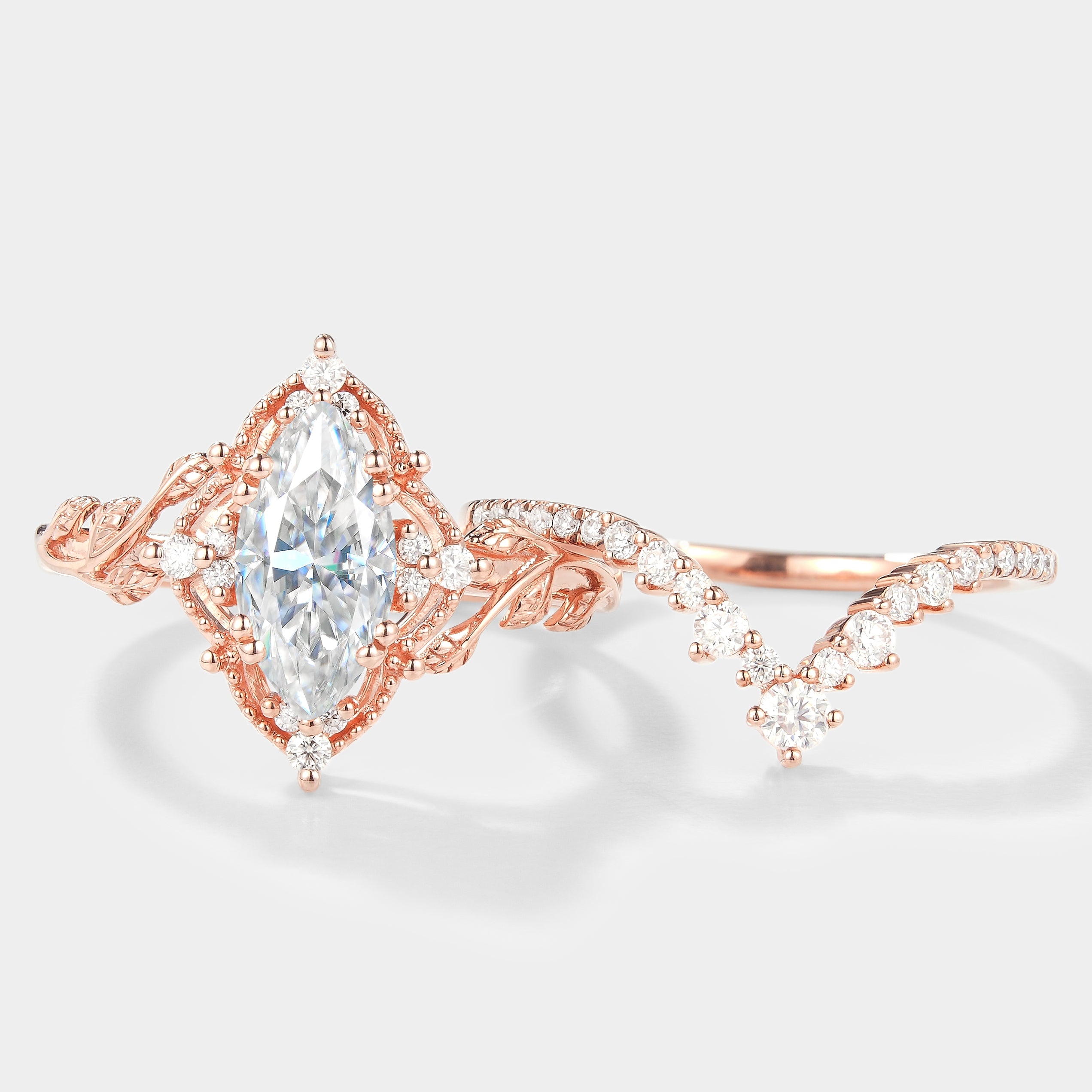 Rose gold marquise moissanite engagement ring set with leaf accents