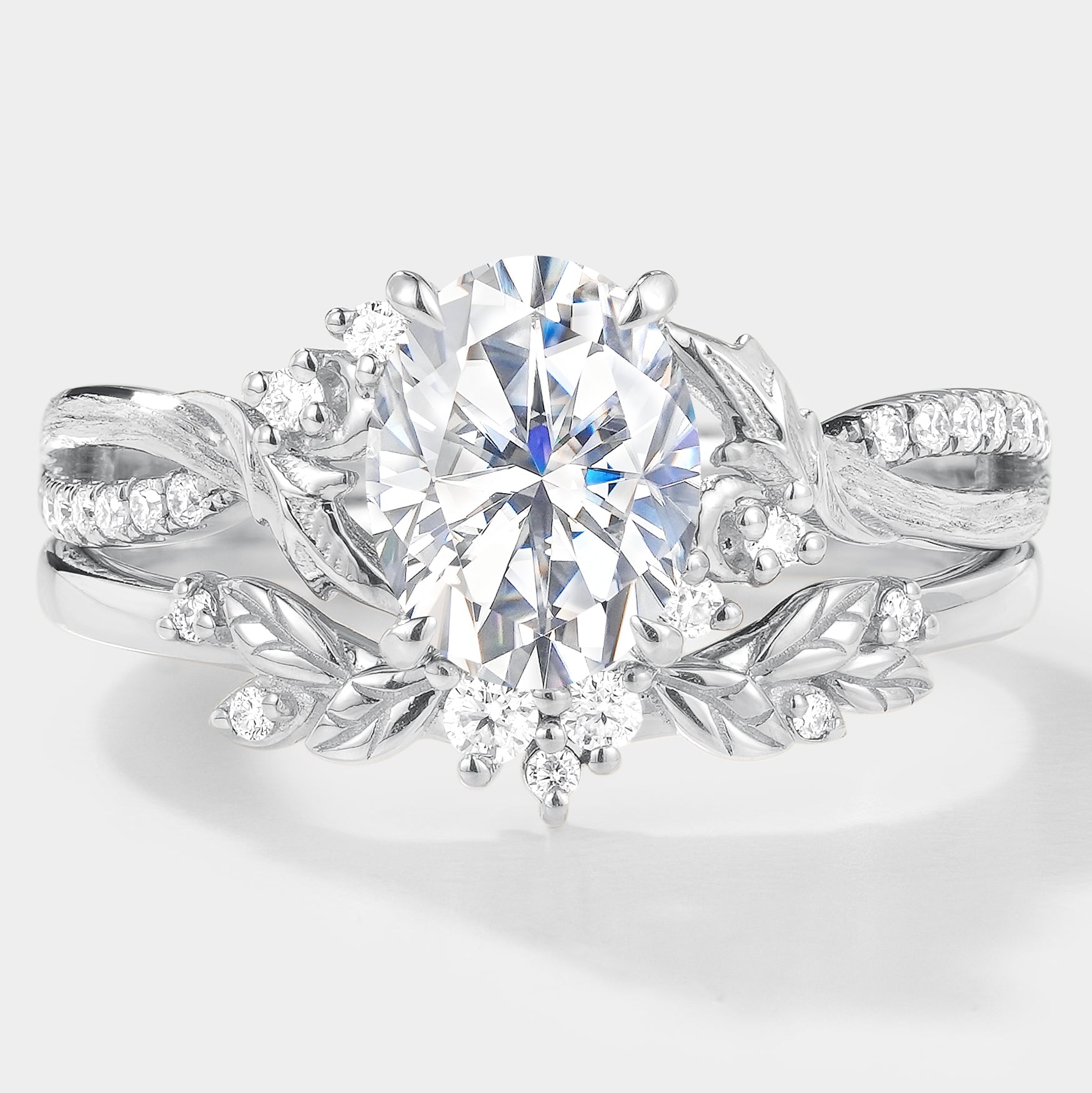 Oval moissanite engagement ring set with leaf accents