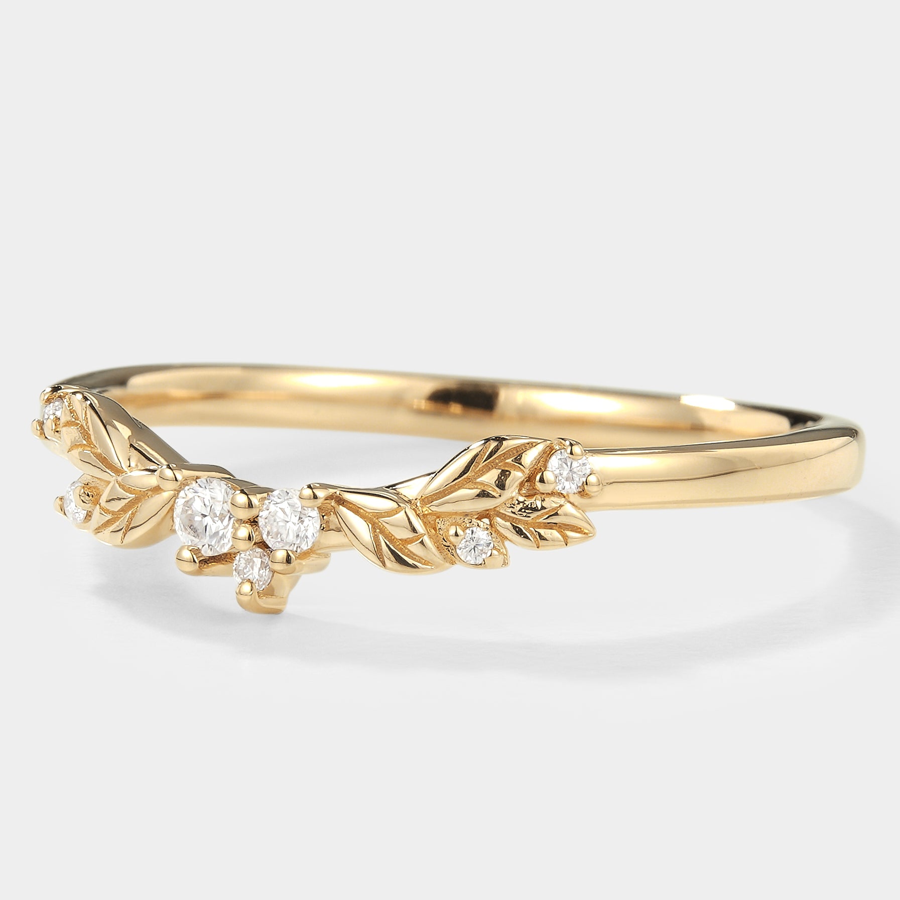 Gold leaf pattern wedding band with moissanite stones. Nature-inspired design