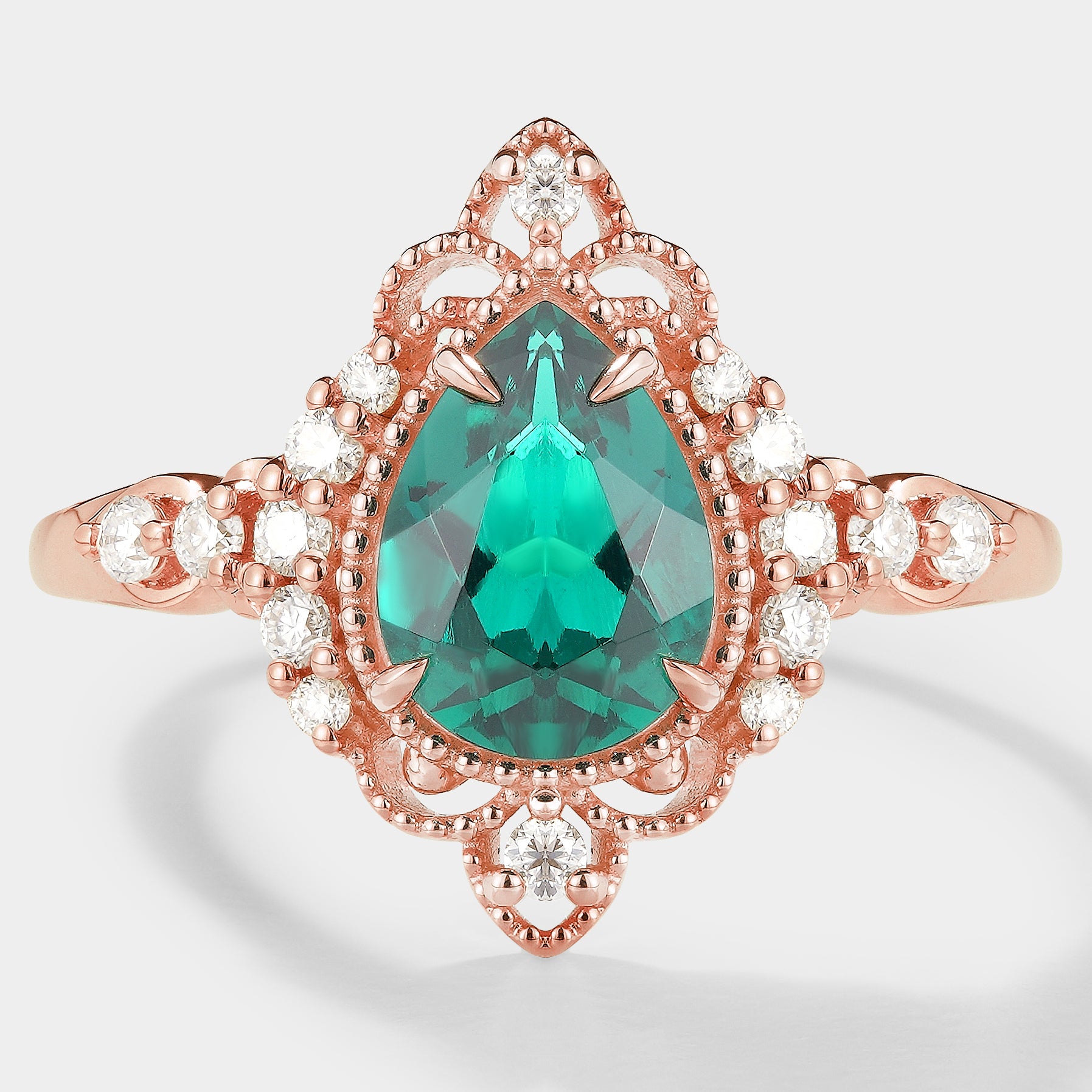 Vintage-inspired pear cut emerald engagement ring