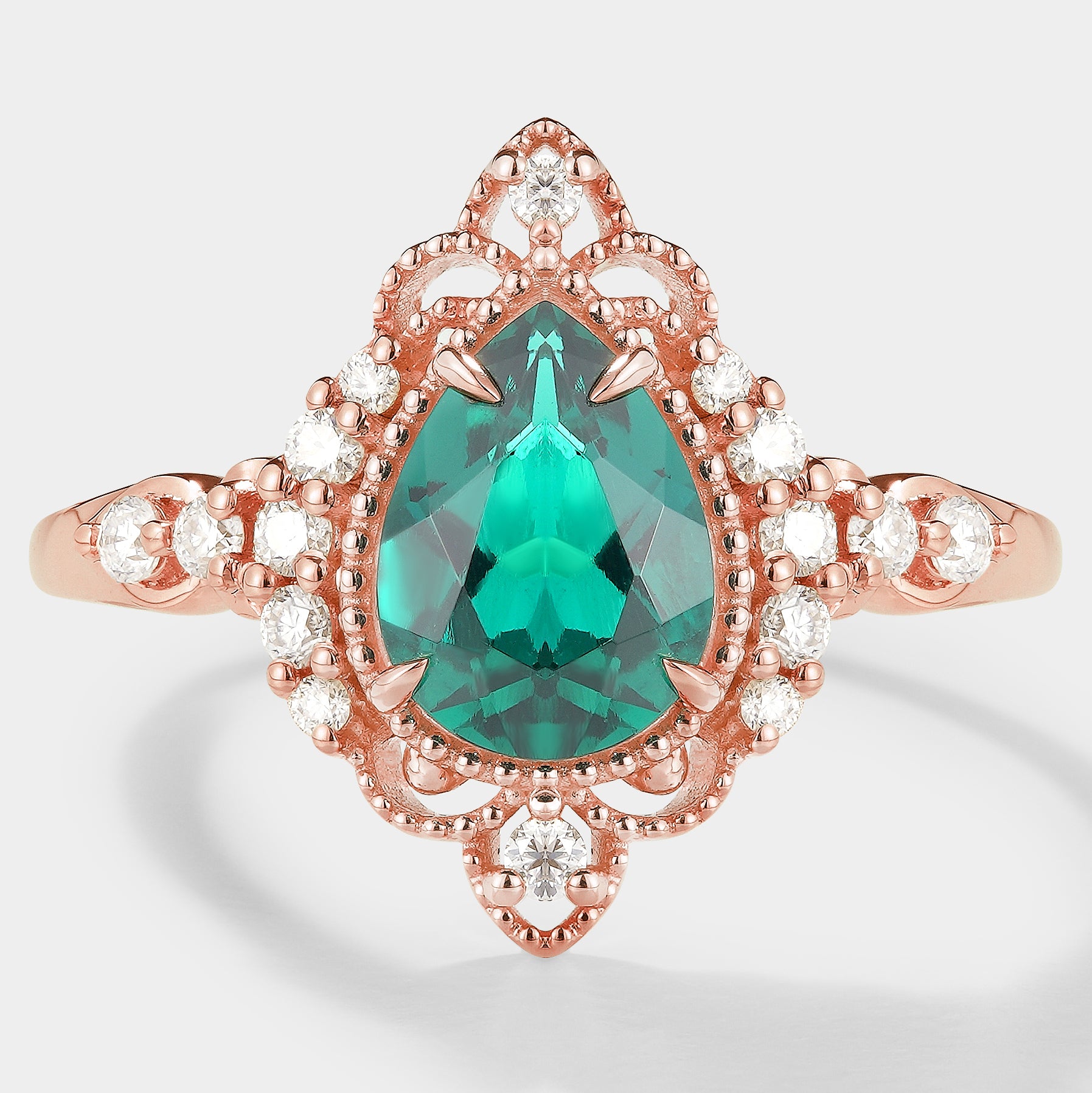 Vintage-inspired pear cut emerald engagement ring