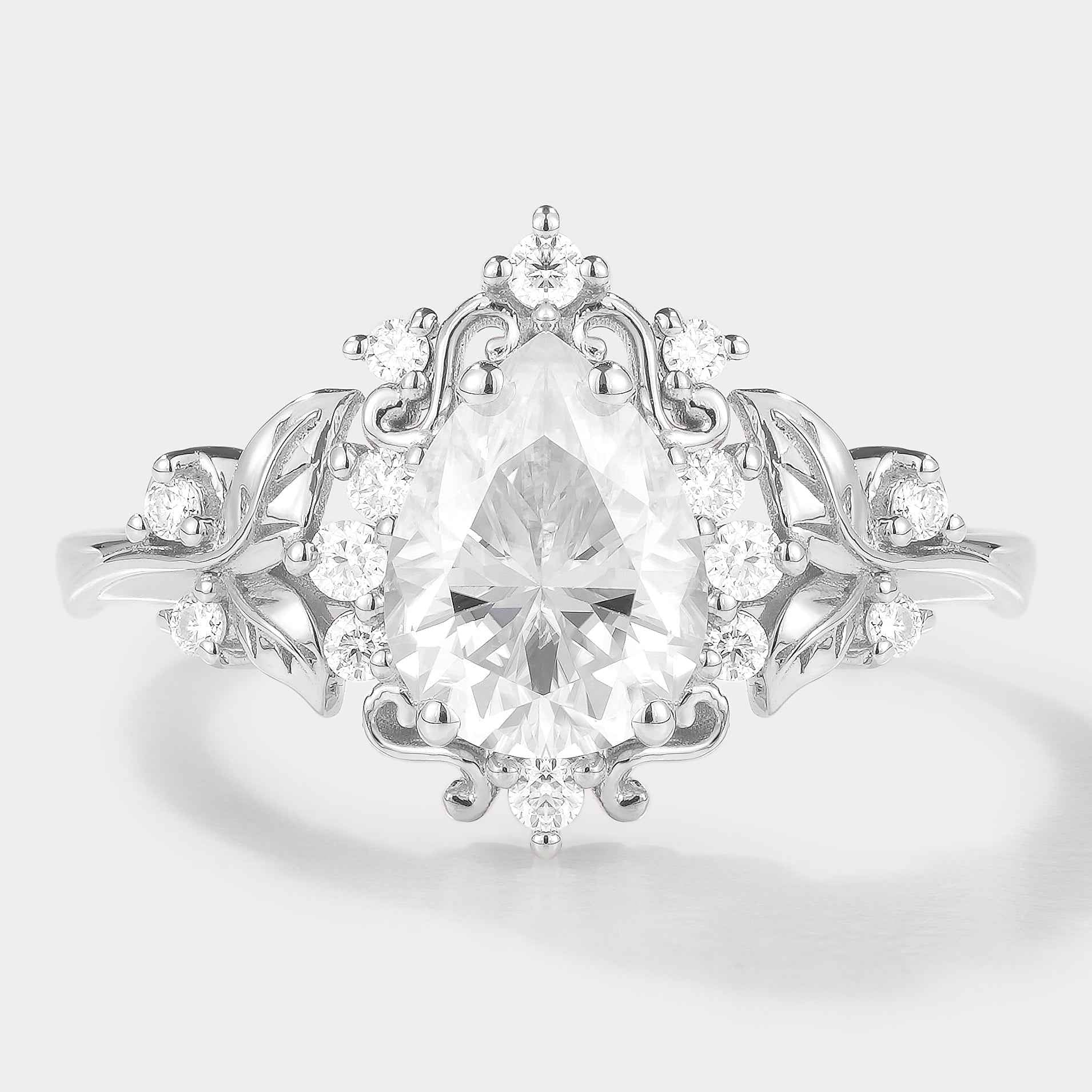Vintage-inspired pear cut moissanite engagement ring with leaf accents