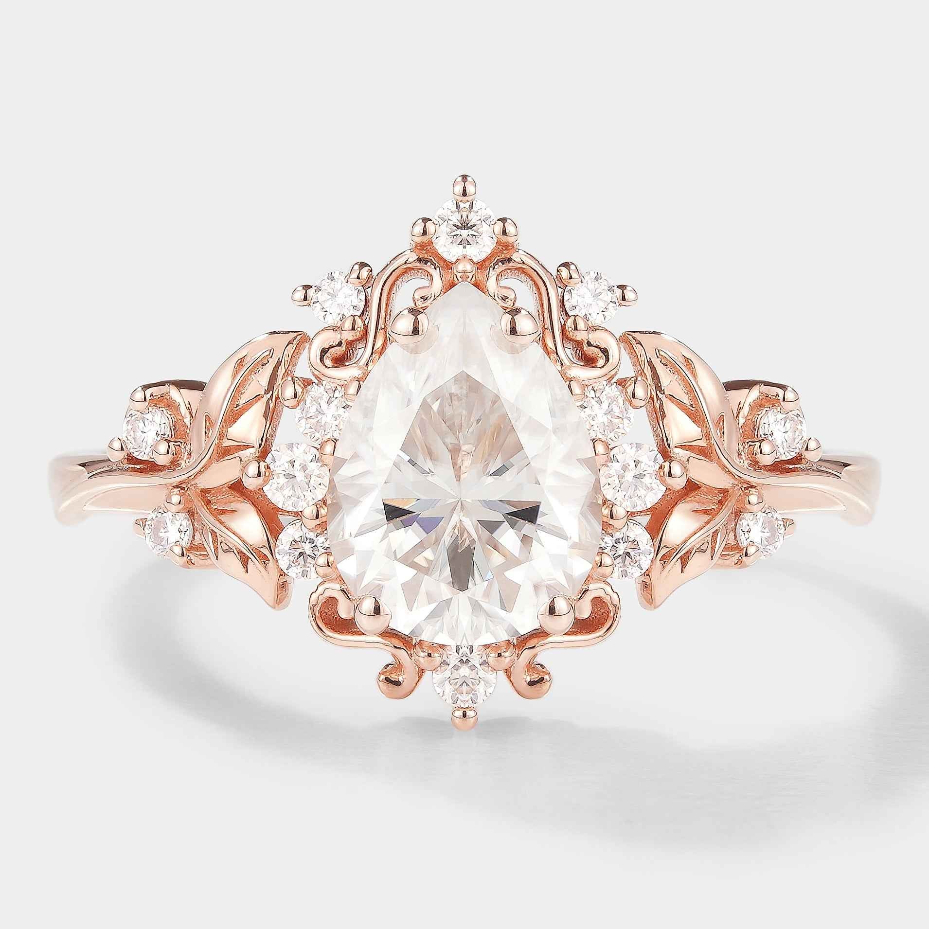 Pear cut moissanite engagement ring with leaf details