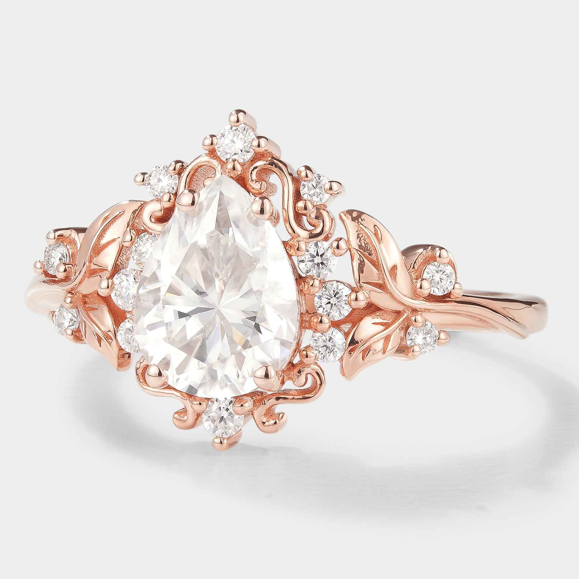 Rose gold leaf-inspired pear cut moissanite engagement ring