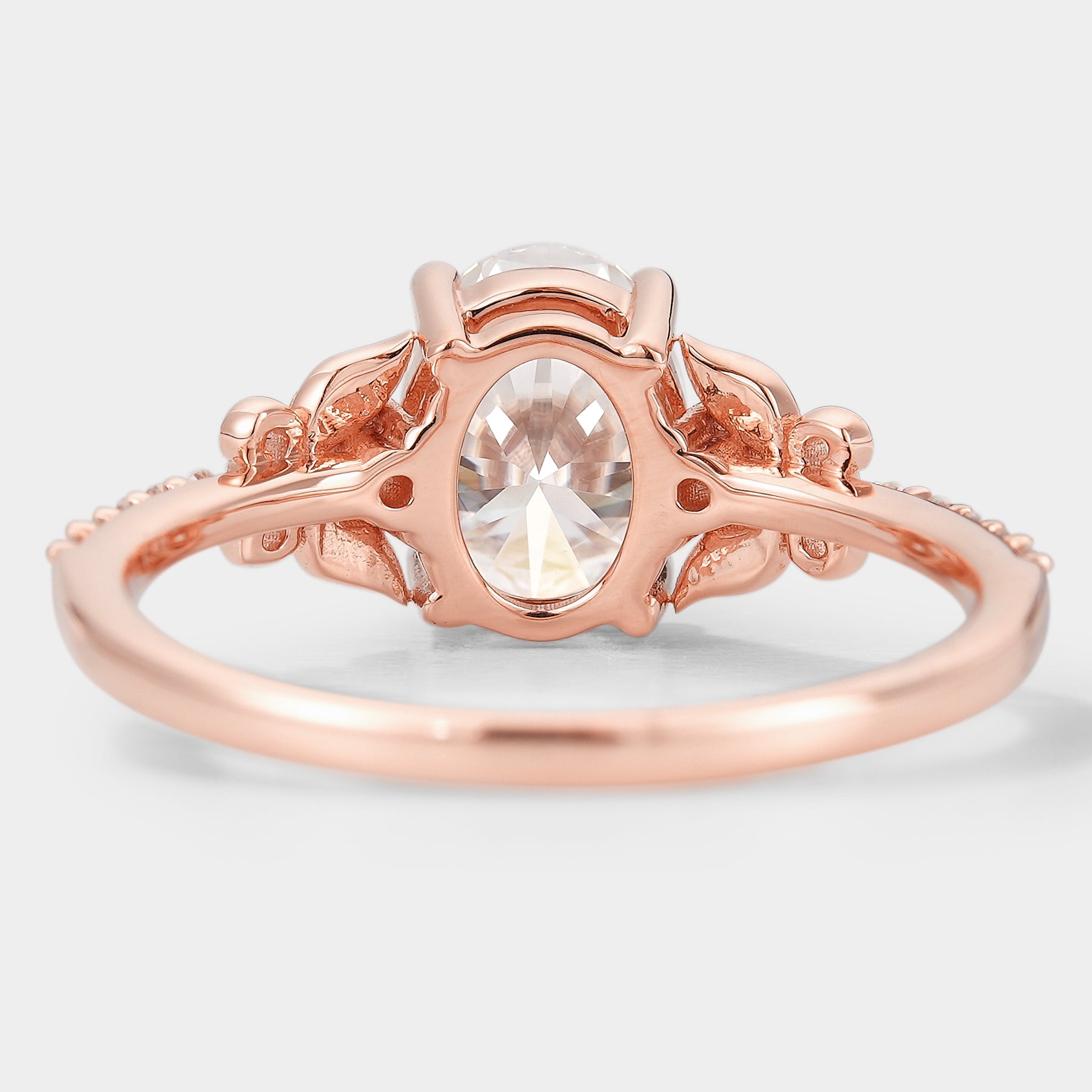 Rose gold leaf-inspired engagement ring with oval moissanite