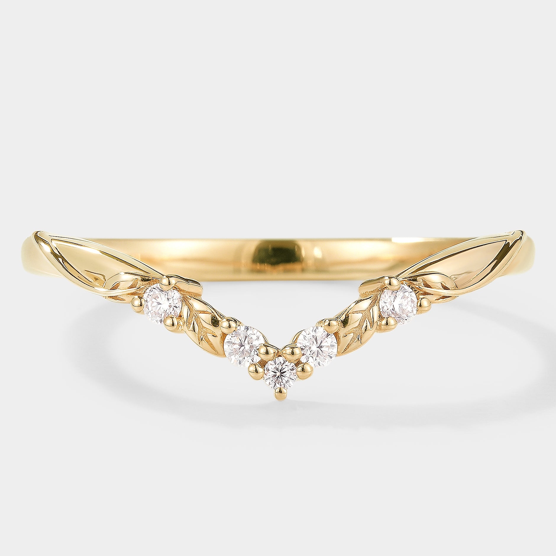 Nature-inspired V-shaped leaf moissanite wedding band in yellow gold